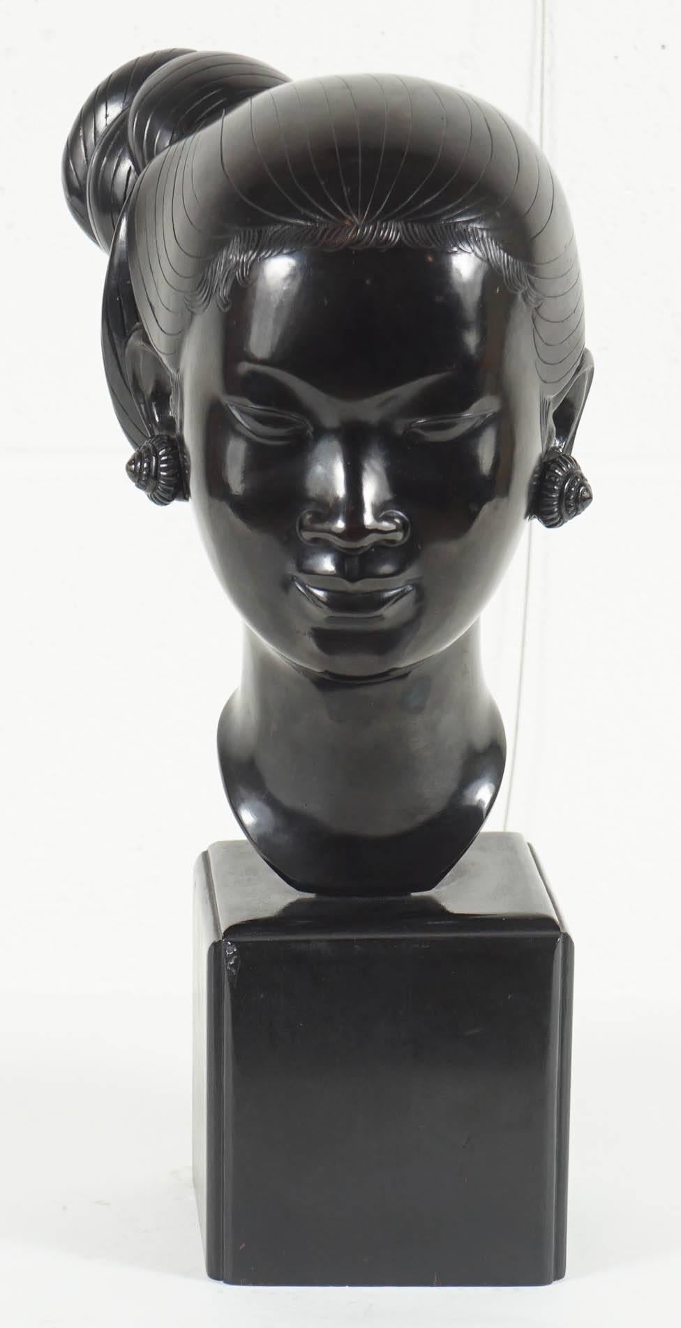 Here is a beautiful bronze sculpture of an Asian girl mounted on a solid black lacquered wood base. This piece has a highly stylized design with contour lines throughout for detail. There is an incised maker mark in the bronze on the back.