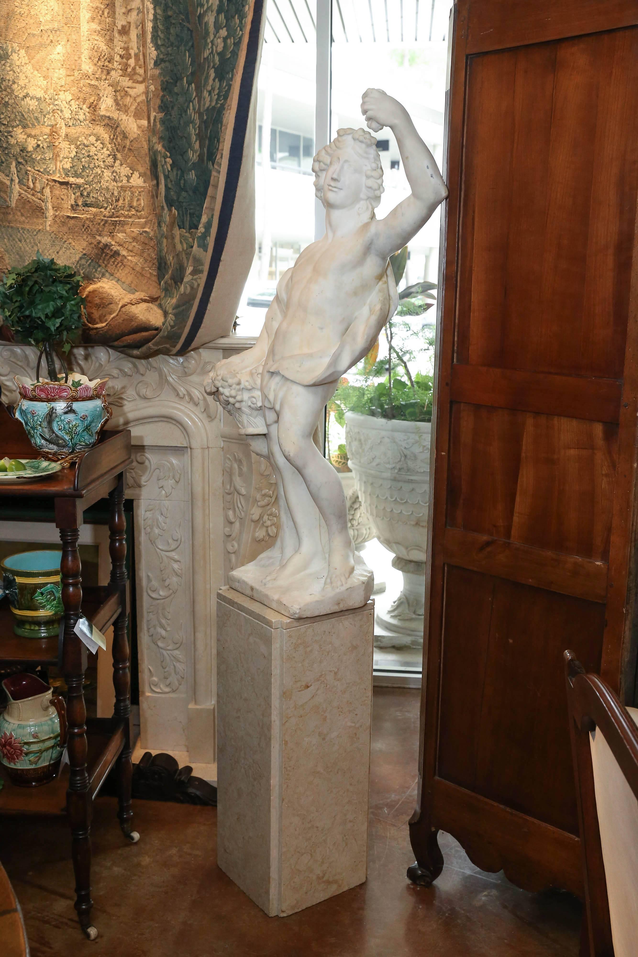 Carved Italian Marble Statue of Bacchus holding a basket  of fruit and flowers For Sale