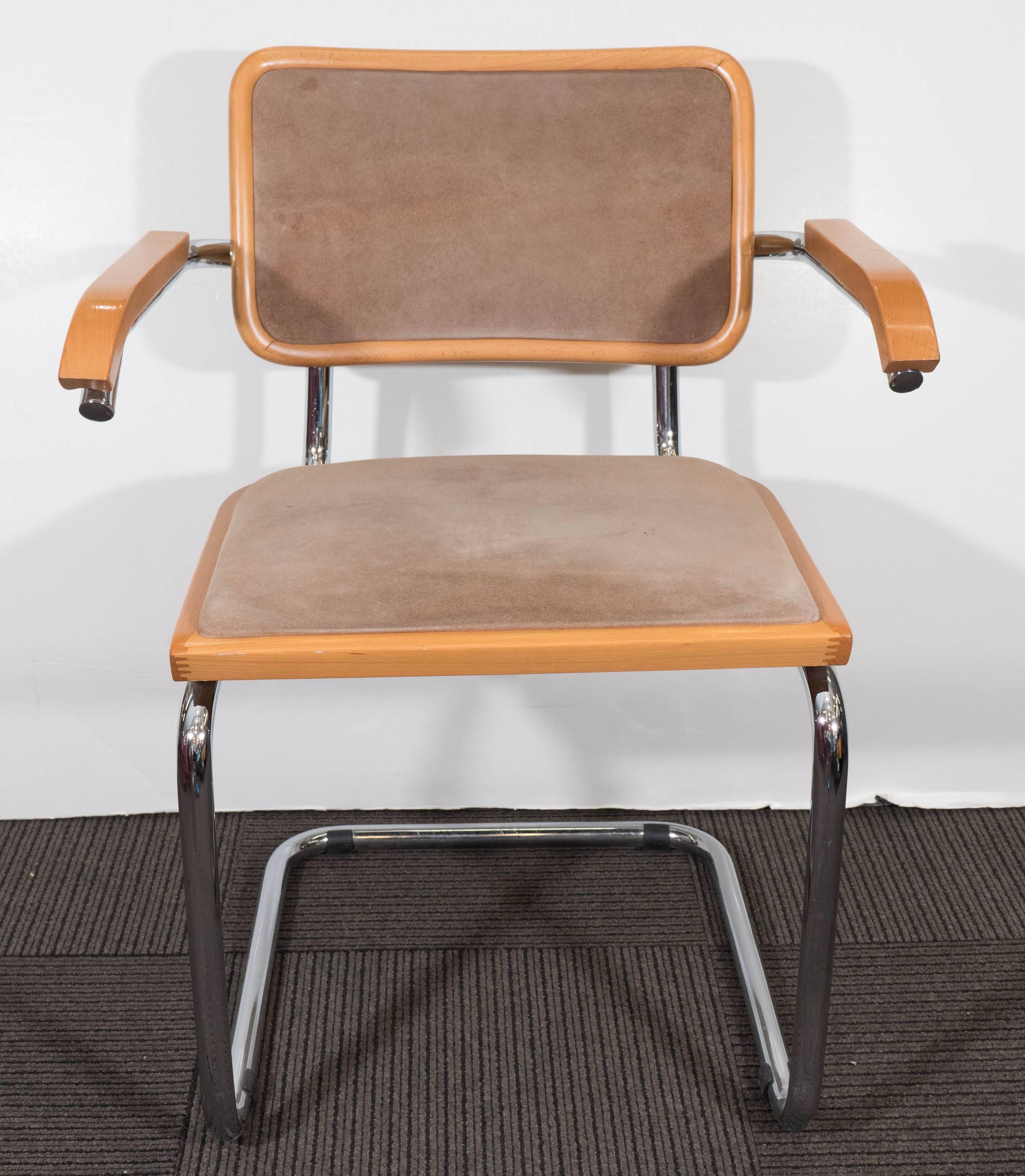 This vintage armchair, produced in Italy circa 1970s, is based on the Bauhaus style 'Cesca Chair', originally designed by Marcel Breuer in 1928. This version includes suede upholstered seat and back in taupe, and lacquered warm beech wood frame and
