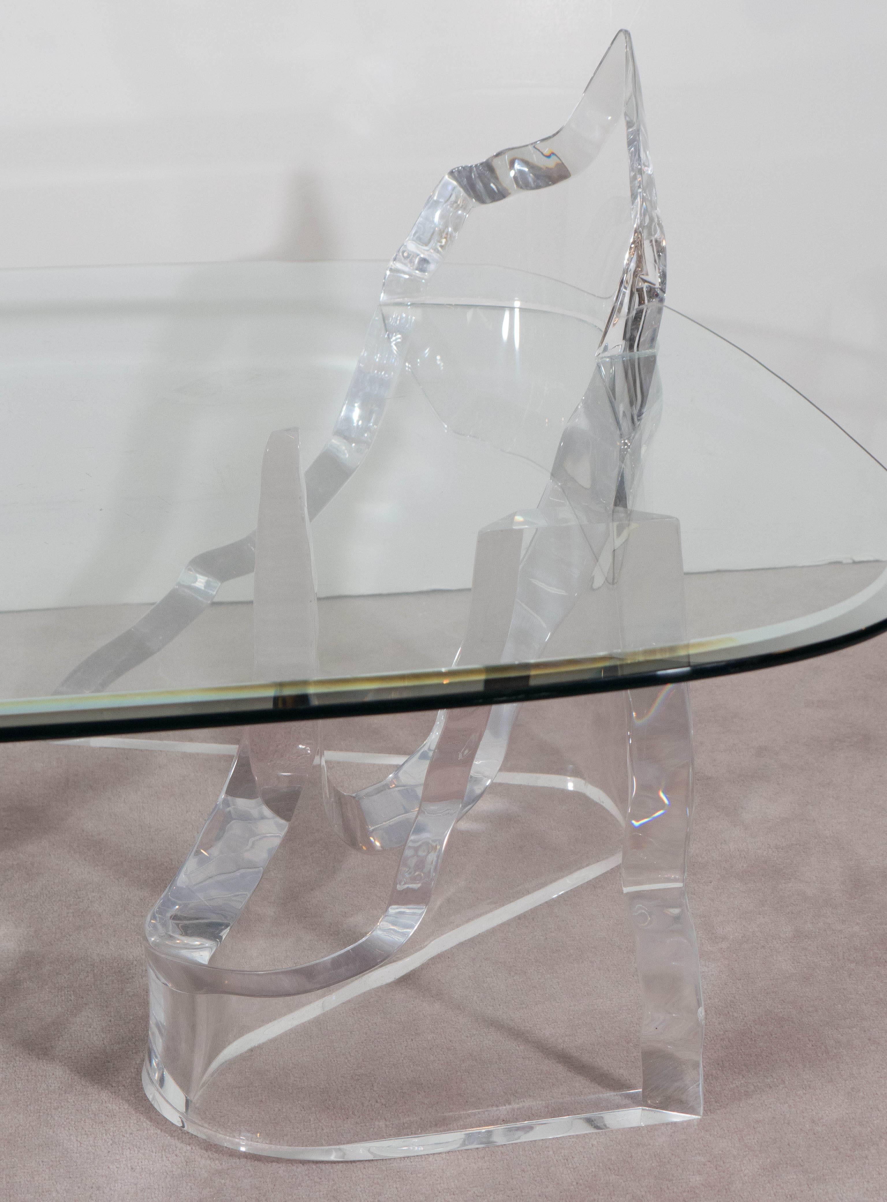 A highly sculptural coffee table by Lion in Frost, produced circa 1970s-1980s, with square rounded corner glass top with beveled border, on Lucite base, designed to appear as jagged iceberg shards. Markings include [Lion in Frost] to the Lucite
