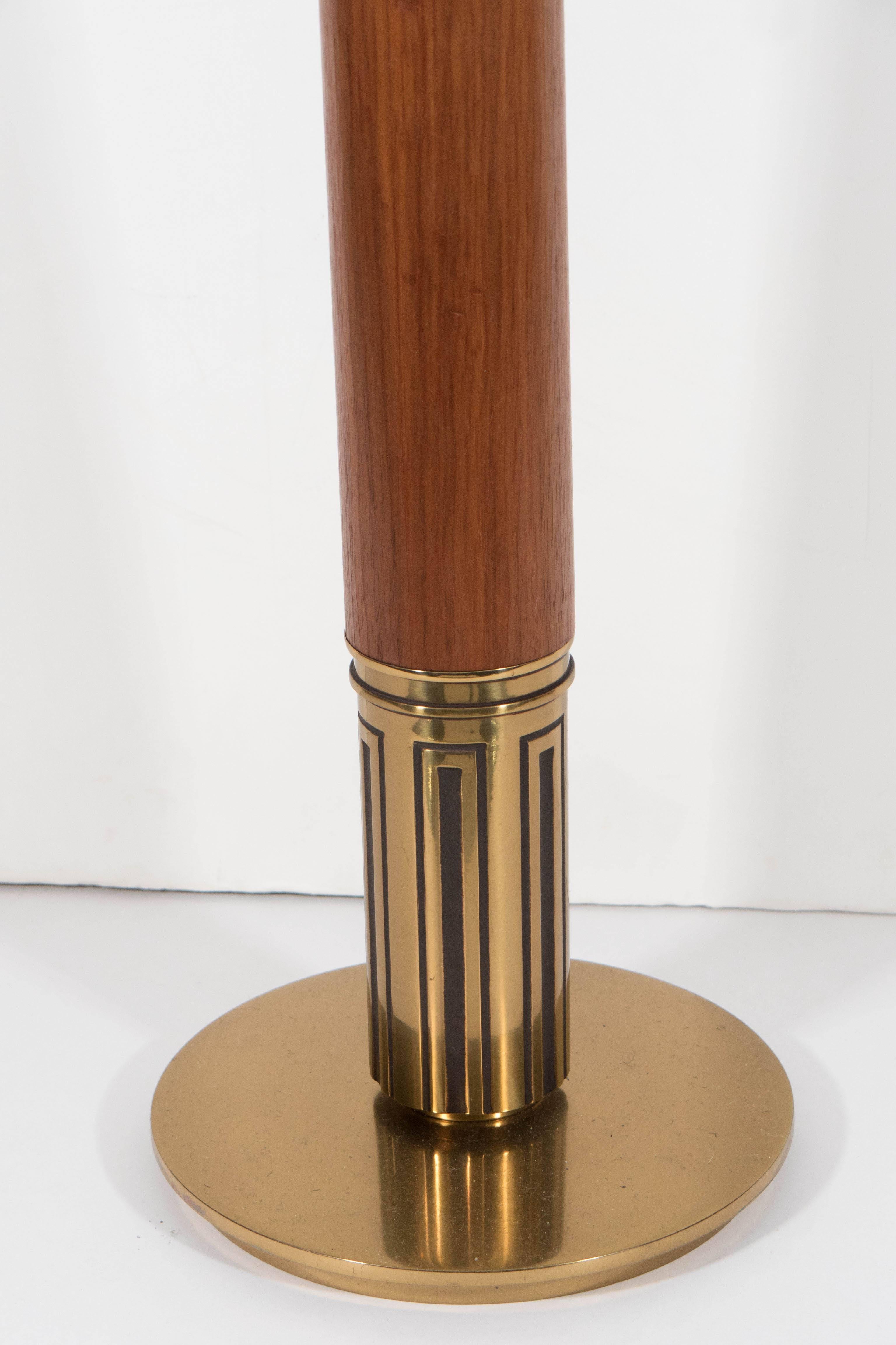 A pair of lengthy table lamps by Stiffel, manufactured circa 1970s and designed in the manner of designer Tommi Parzinger, each with single socket, over brass stem, with decorative bobeche and walnut accent on circular base. Includes three-way