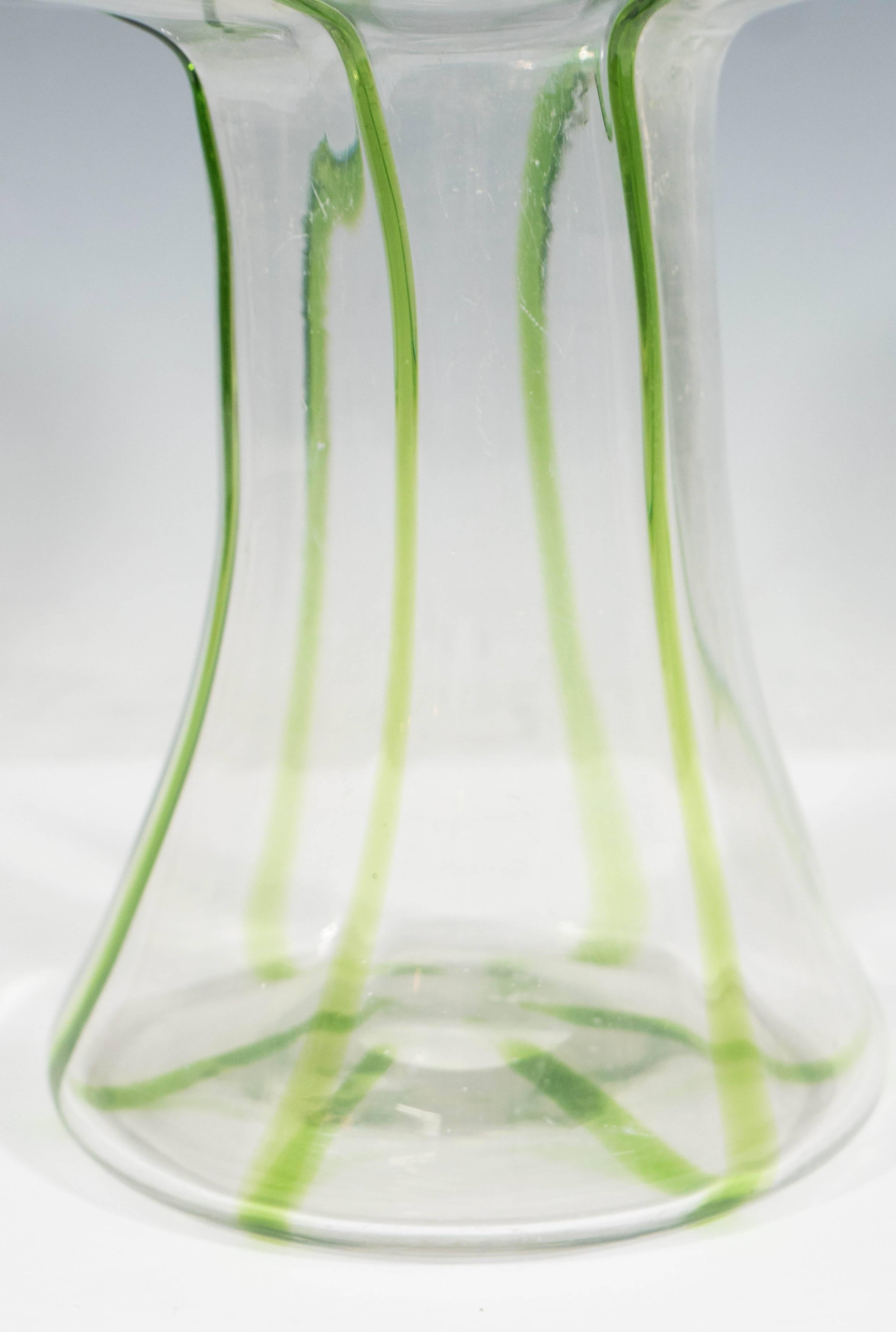 An early 20th century handblown glass vase by Stuart & Sons, reflecting the organic Art Nouveau style, with folded rim and bulbous top, detailed with green and turquoise peacock eye trails (otherwise known as 'Cairngorm'). The vase remains in very