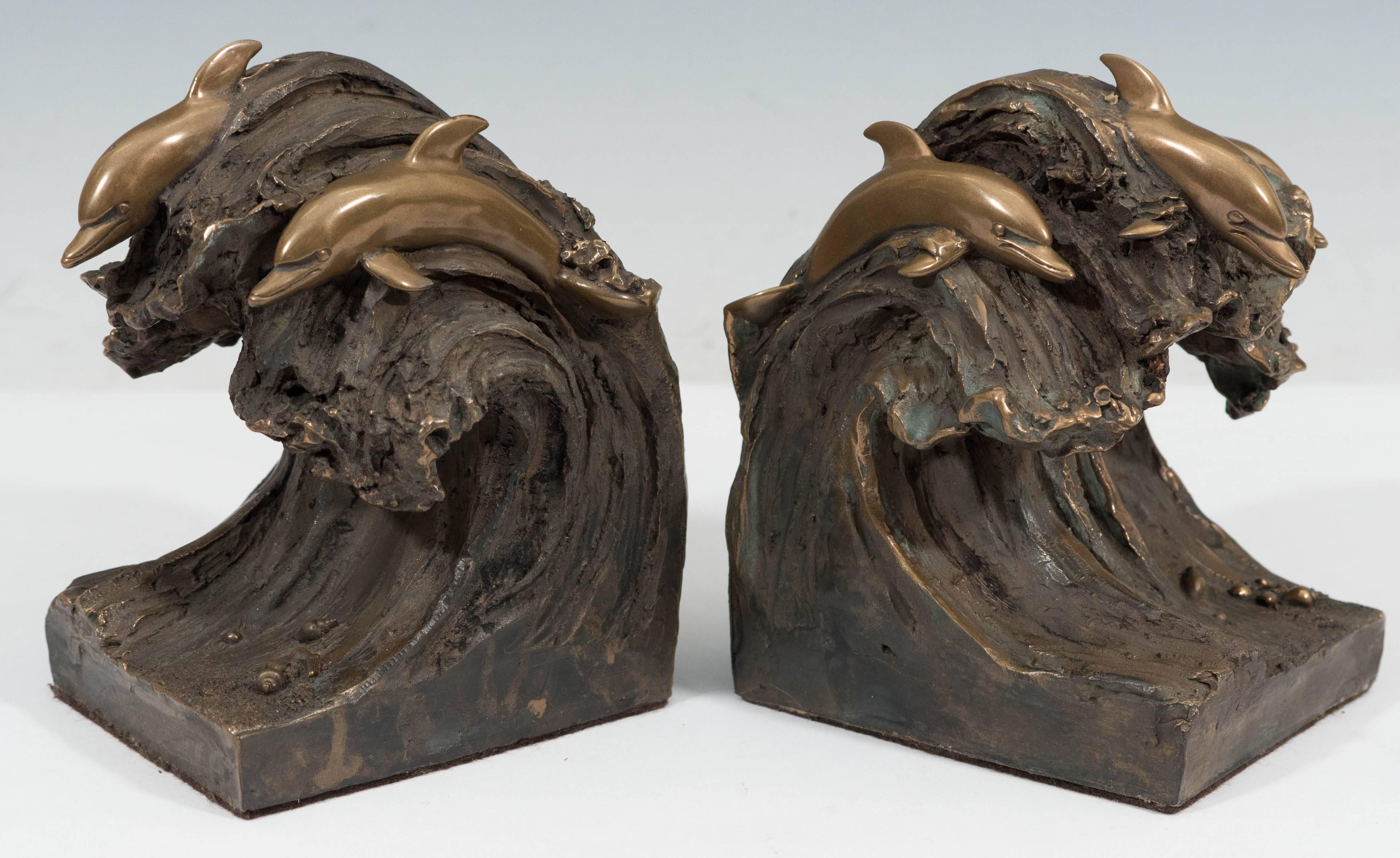 A pair of sculptural bronze bookends by Joseph Addotta, each a beautiful display of artfully polished dolphin trios, riding a crashing wave. Markings include signature [Addotta 1967 ©] to the lower back of each. Very good vintage condition,