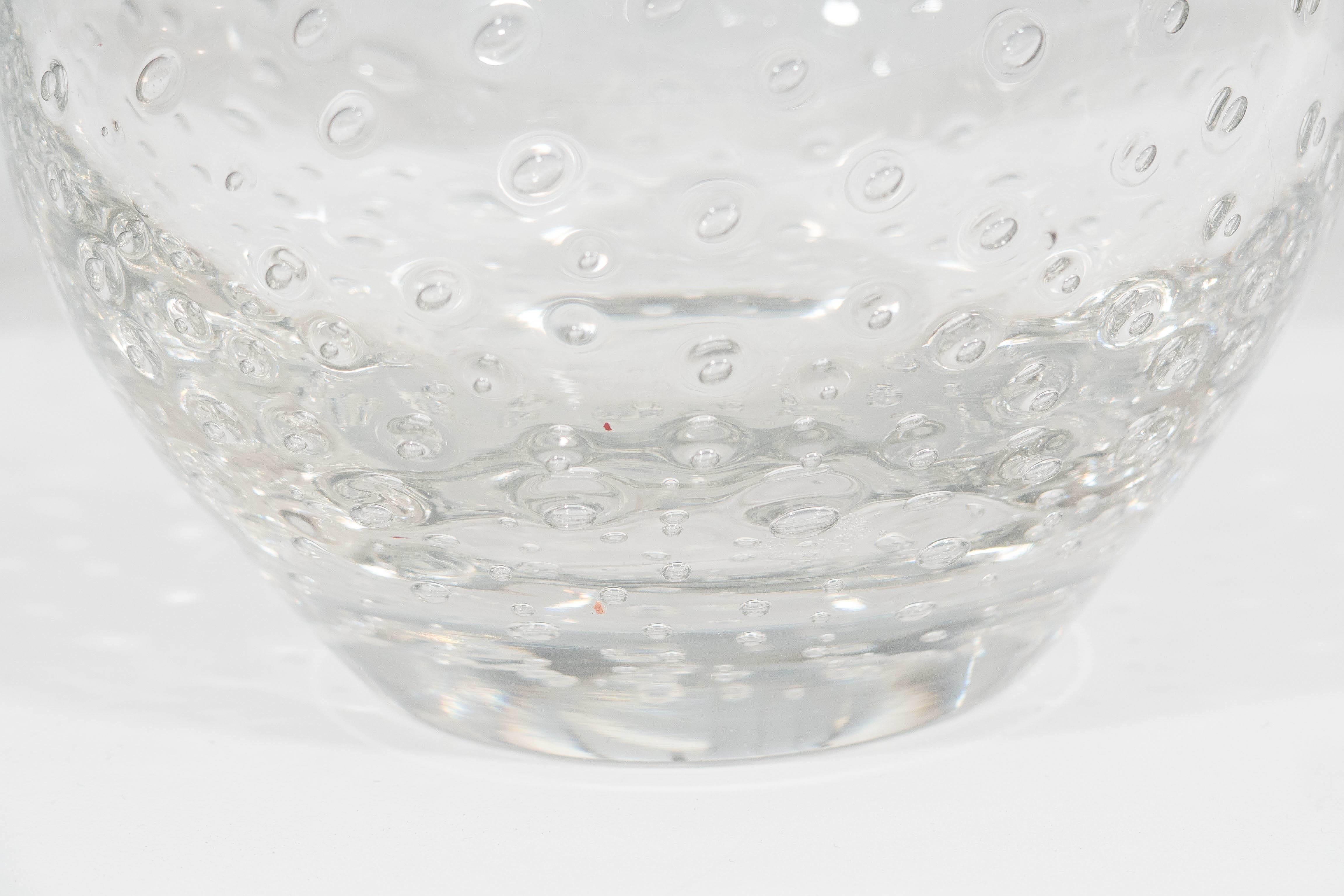 A vintage blown glass vase, originating from Sweden, with rounded body and controlled bubbles. This piece remains in very good condition, consistent with age and use.