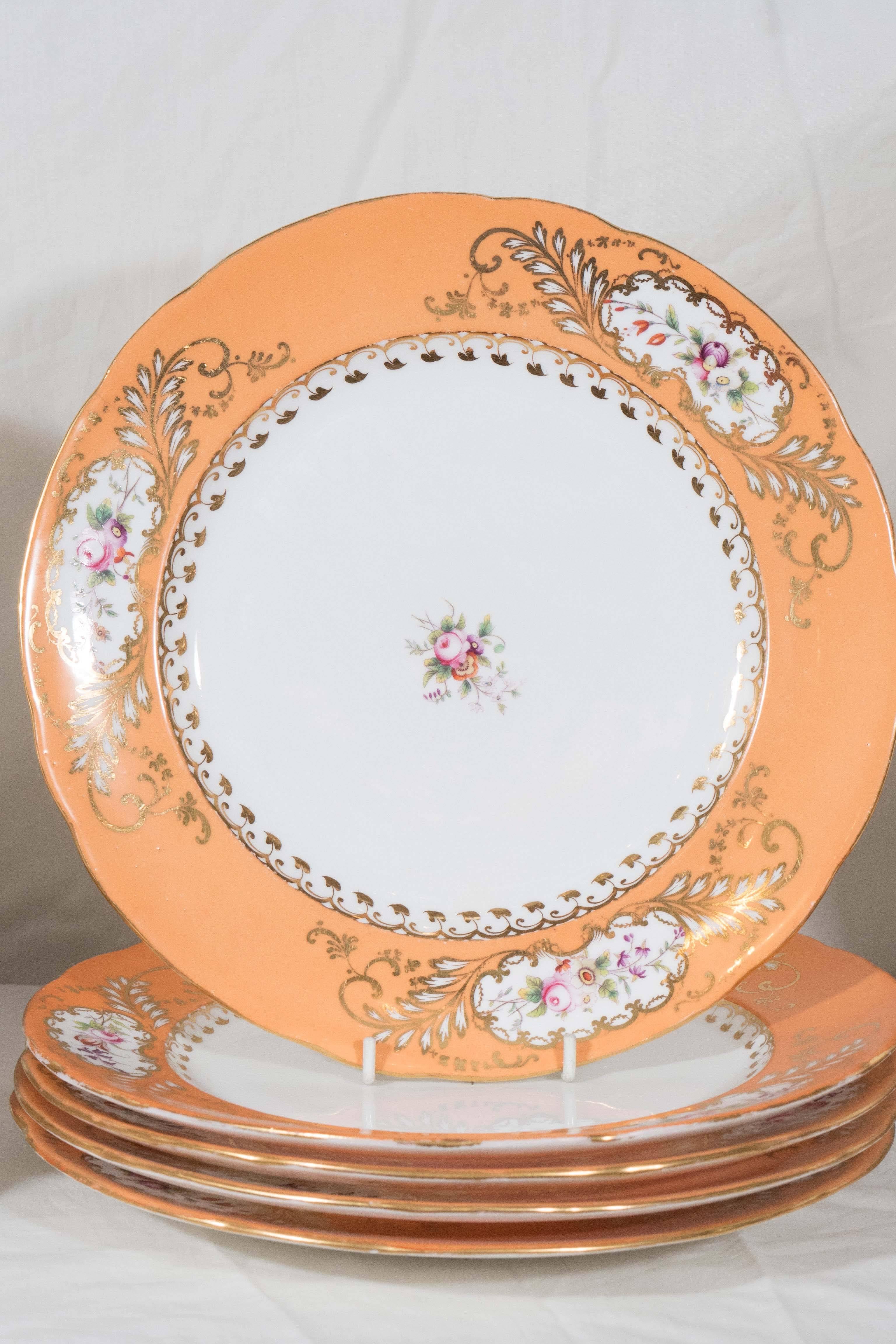 A beautiful set of English antique porcelain dishes the orange borders decorated with delicately painted flower sprigs. The border and the cavetto also decorated with patterns of gilded leaves. In the set are eight dinner dishes (10.25"
