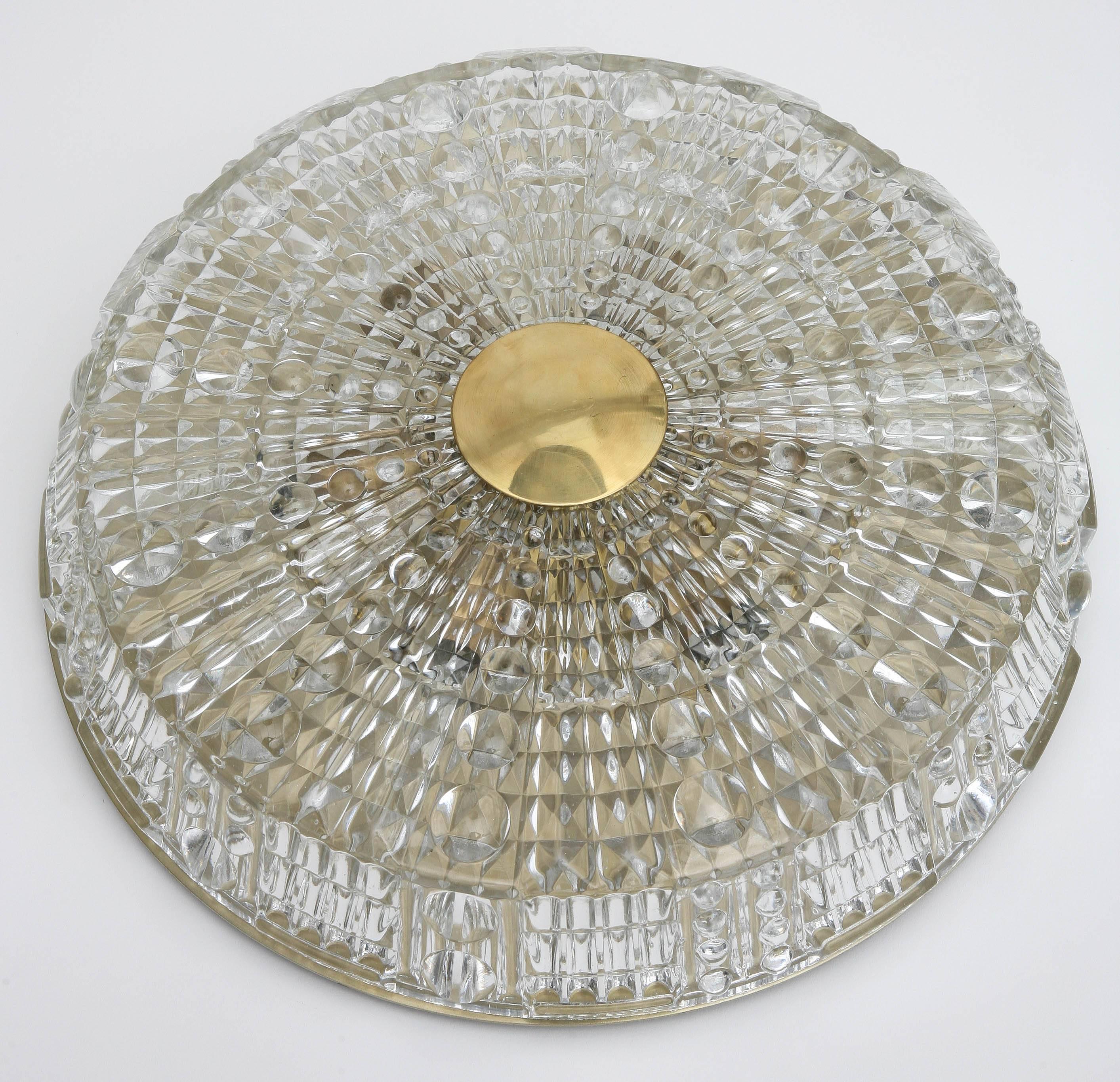 Pair of Orrefors crystal flush mount light fixtures by Carl Fagerlund, Classic.
Orrefors textured crystal in round and diamond design, each have six lights,
gilded brass backplate and round brass top cap, wired to US standards.
Measures: 14.75 in