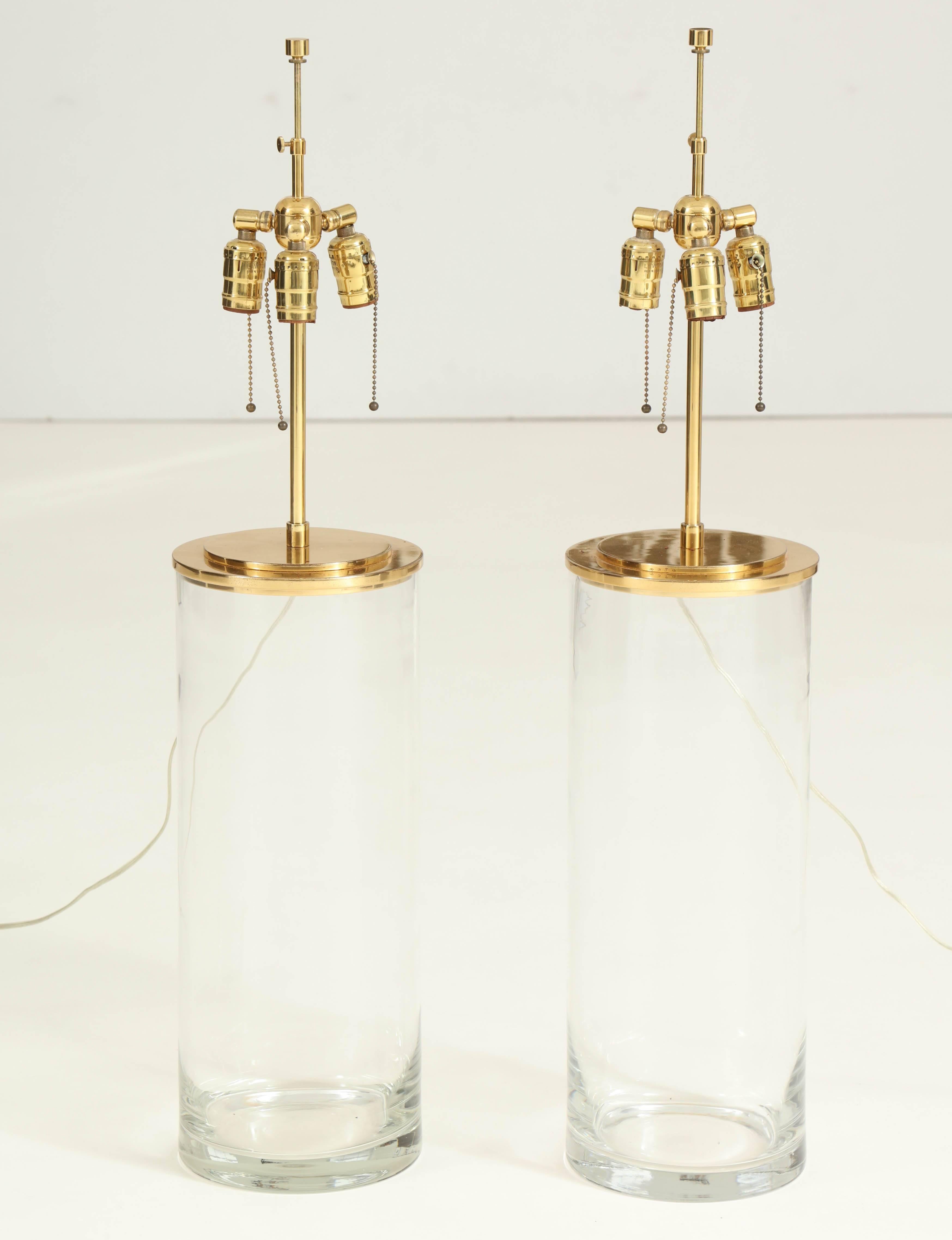 Large chic pair of Minimalist blown glass and brass lamps designed by Harry Hinson for Hansen lamps in the late 1970s. Lamps feature triple socket hardware, and retain their original opaque white paper lamp shades.