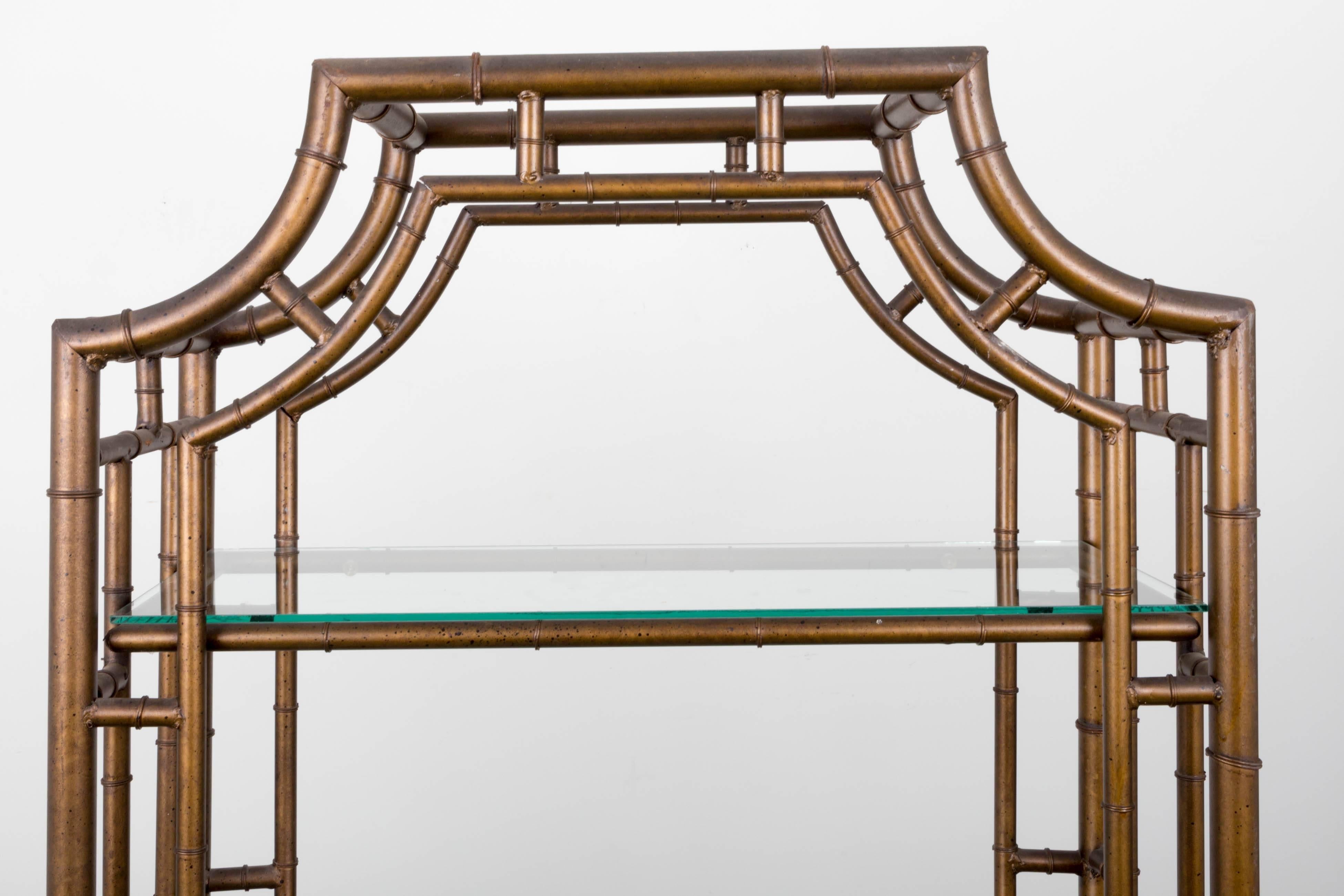 Antiqued gilt finish faux bamboo étagère with five glass shelves.