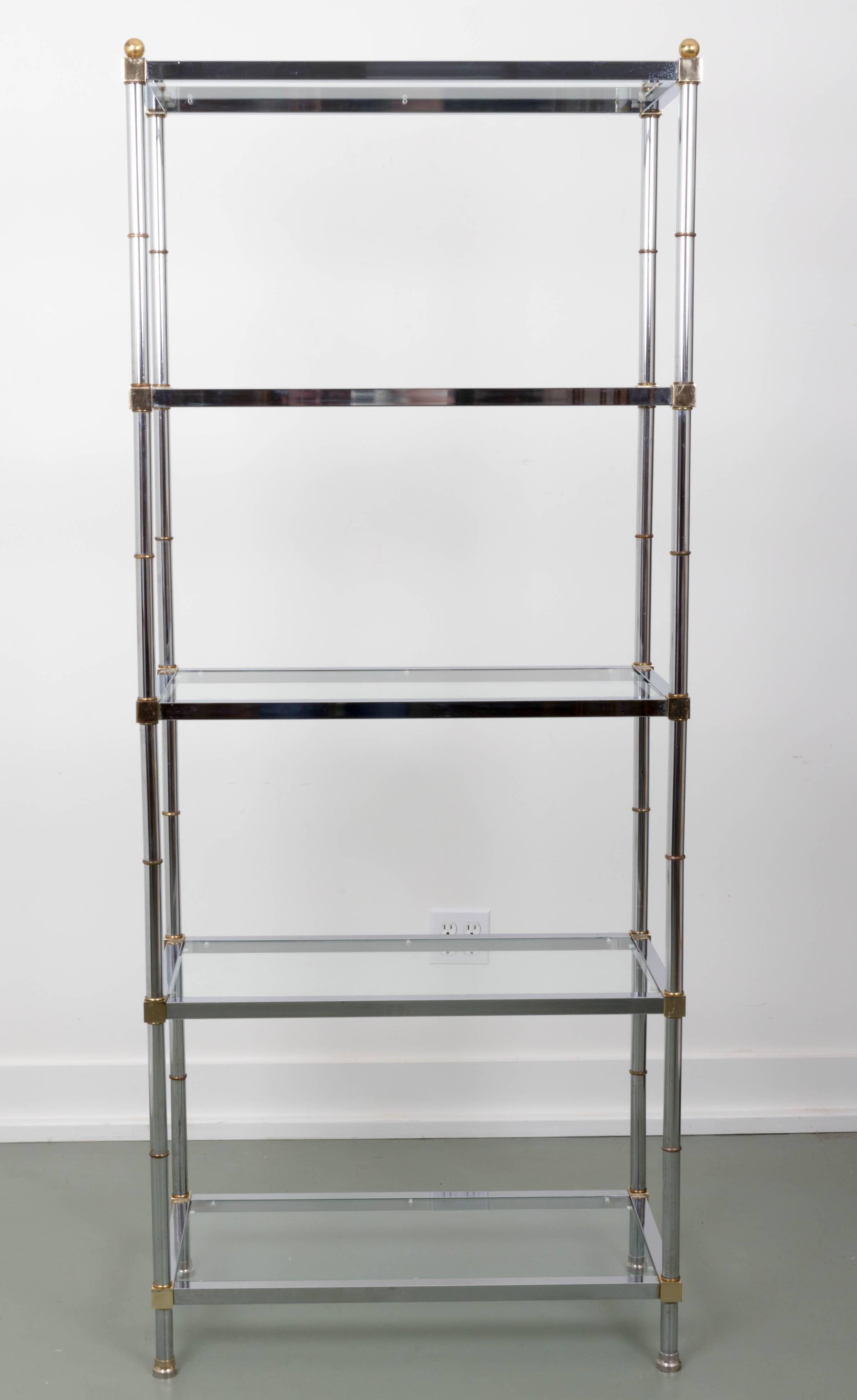 A five glass shelf étagère with chrome frame and brass finials, connecters and feet.