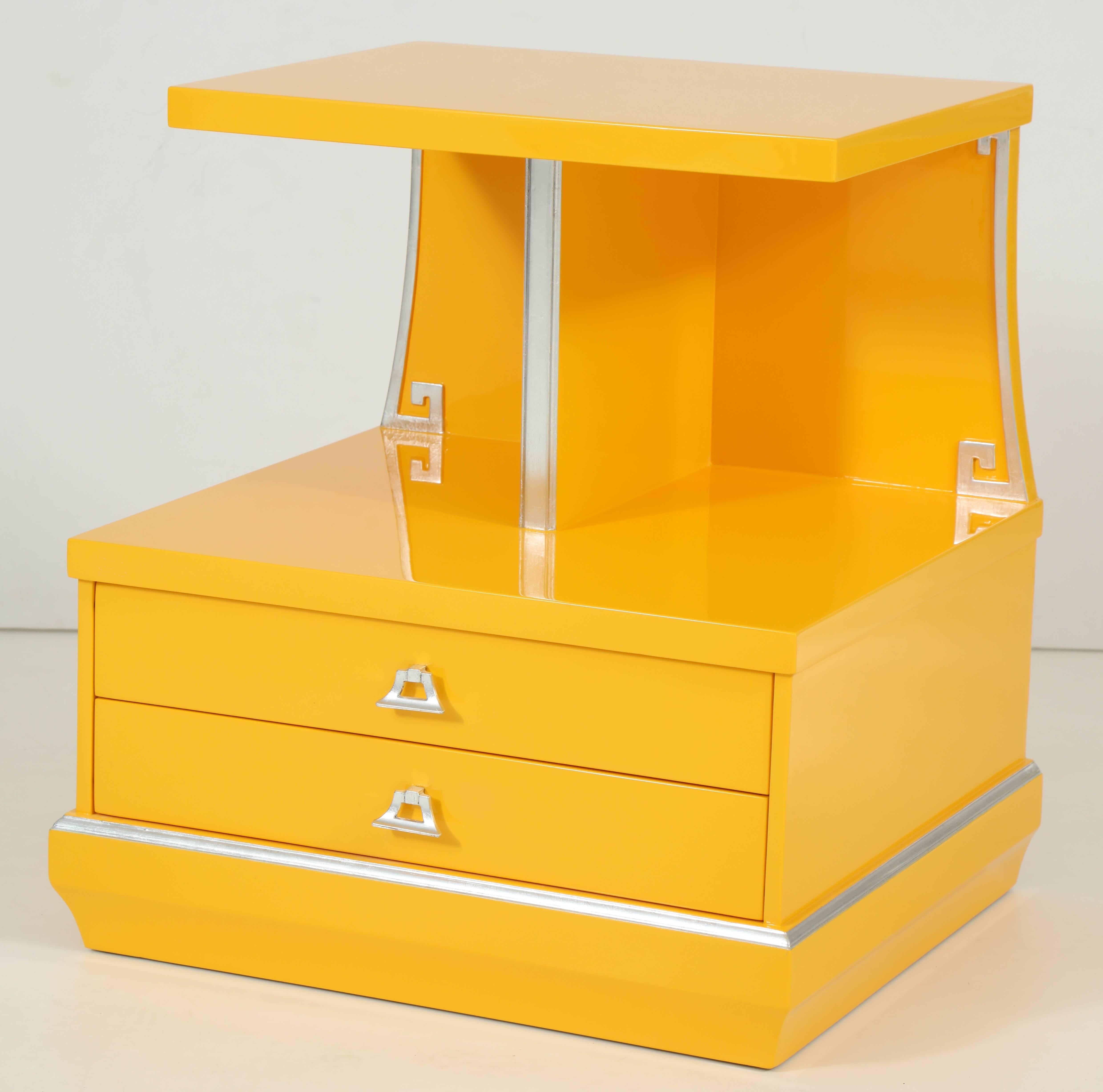 Pair of custom lacquered Art Deco nightstands in a vibrant canary yellow with silver leaf Greek key details and border. Nightstands feature two drawers. Perfect for the Chinoiserie/Tony Duquette setting.