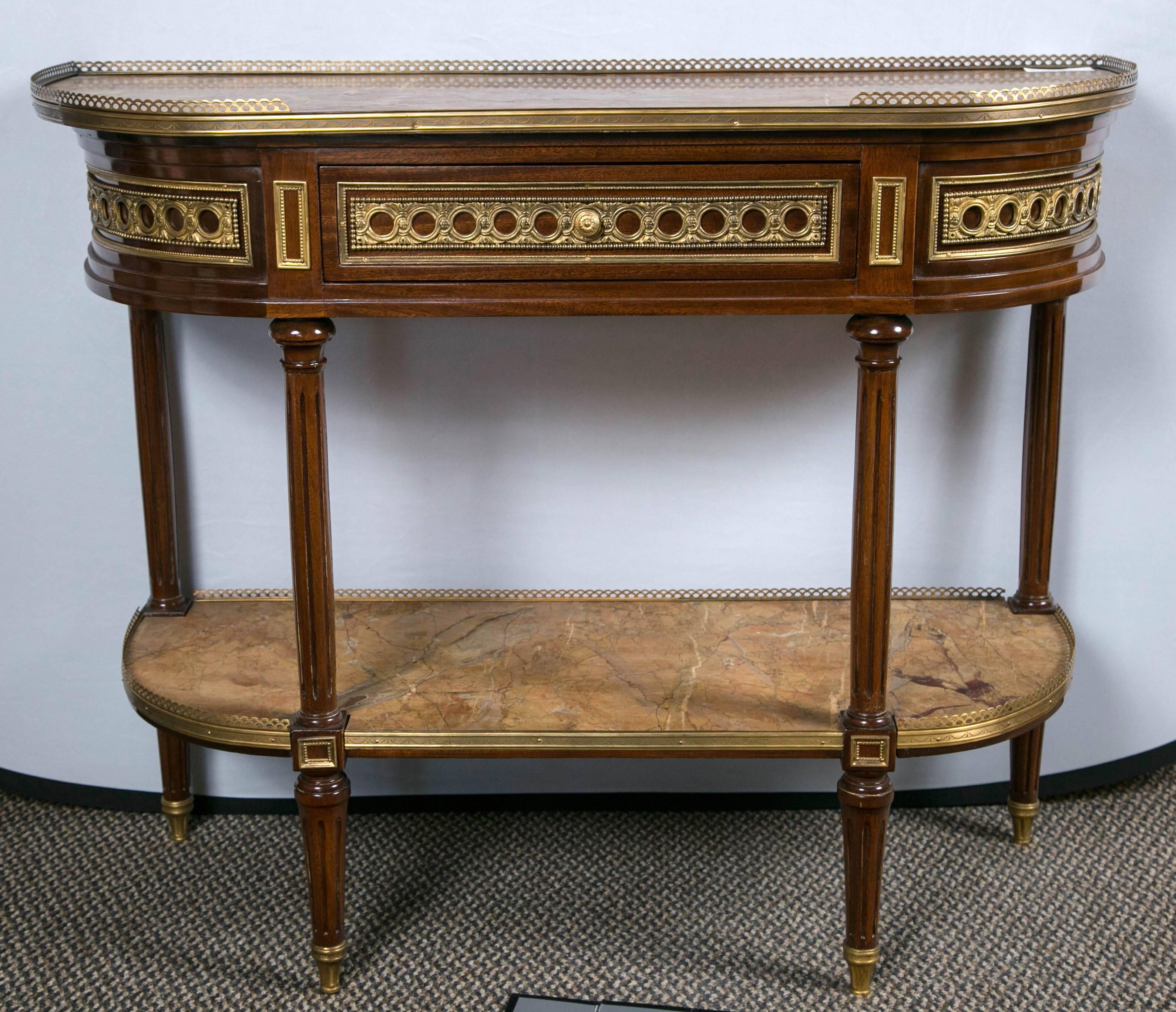 From an old Brookville Long Island mansion come these documented fine French marble-top console / desserts by Maison Jansen. The chiseled bronze of jewelry quality run the length of these one of a kind console tables. Louis XVI stylized legs having