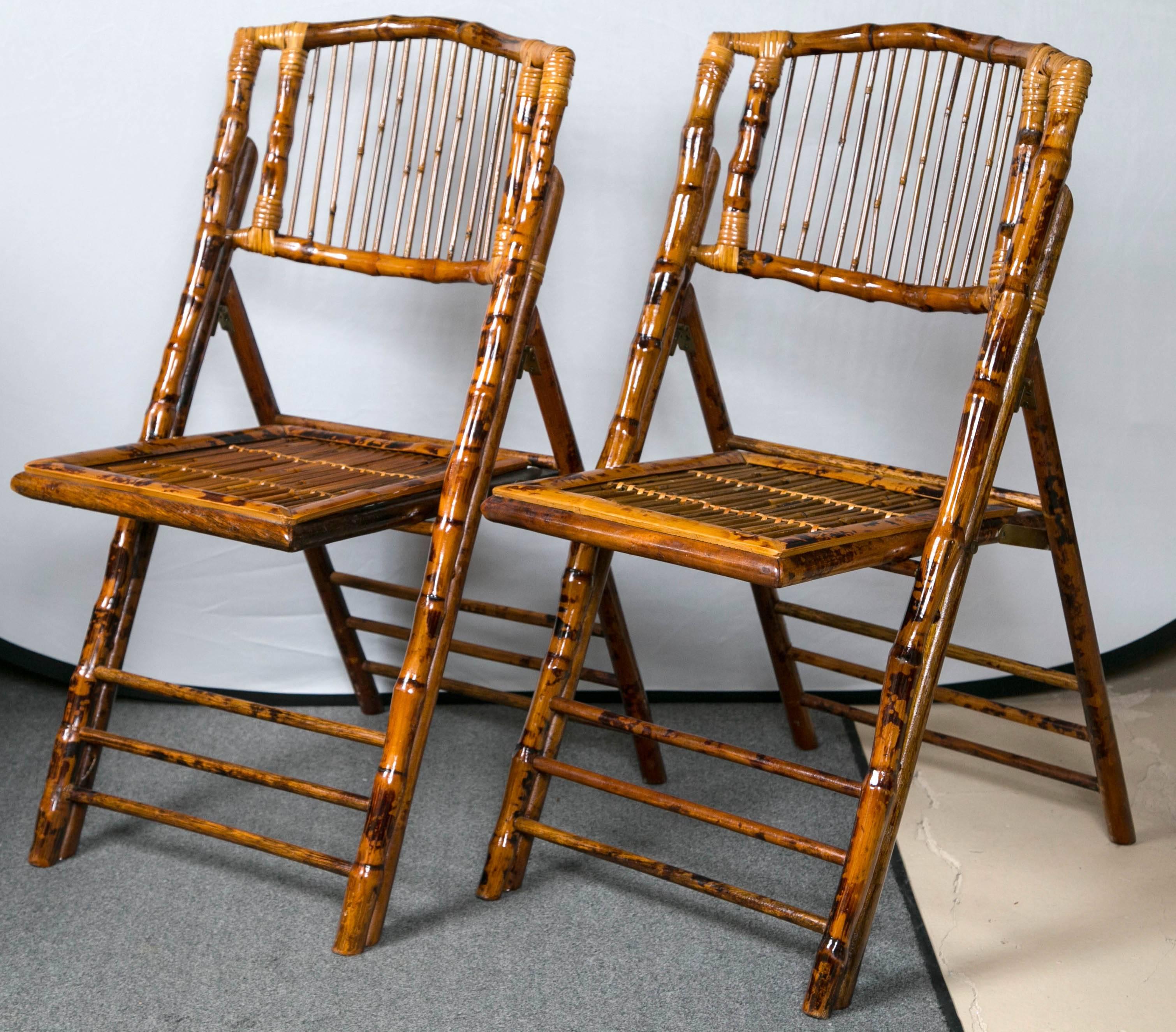 Eight folding tortoise shell and bamboo stylized side chairs. Simply the finest folding side chairs I have ever seen. Each of bamboo form done in a tortoise shell finish with study framed back supports. A wonderful set that would add style to any