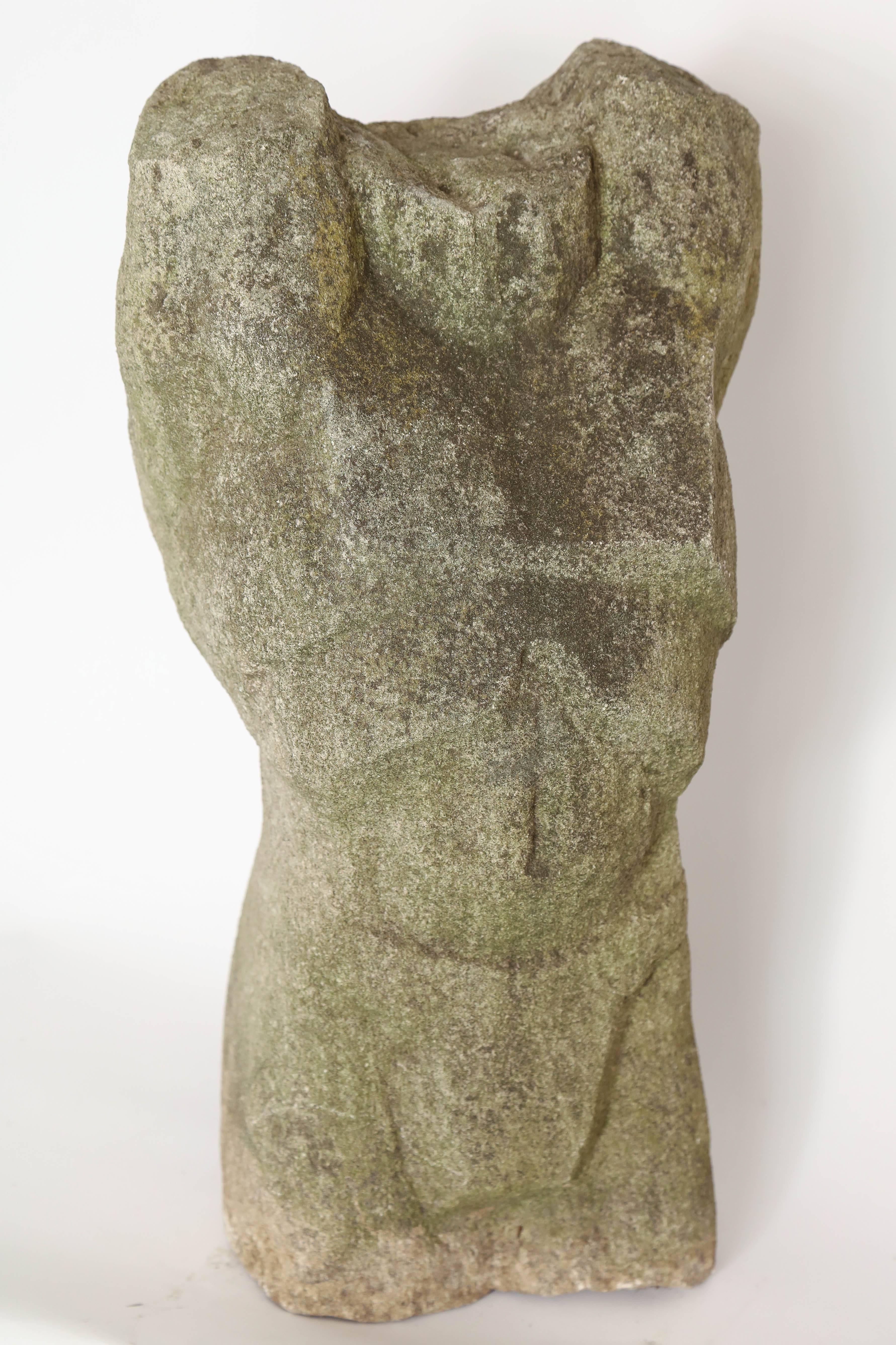 Carved stone torso sculpture.