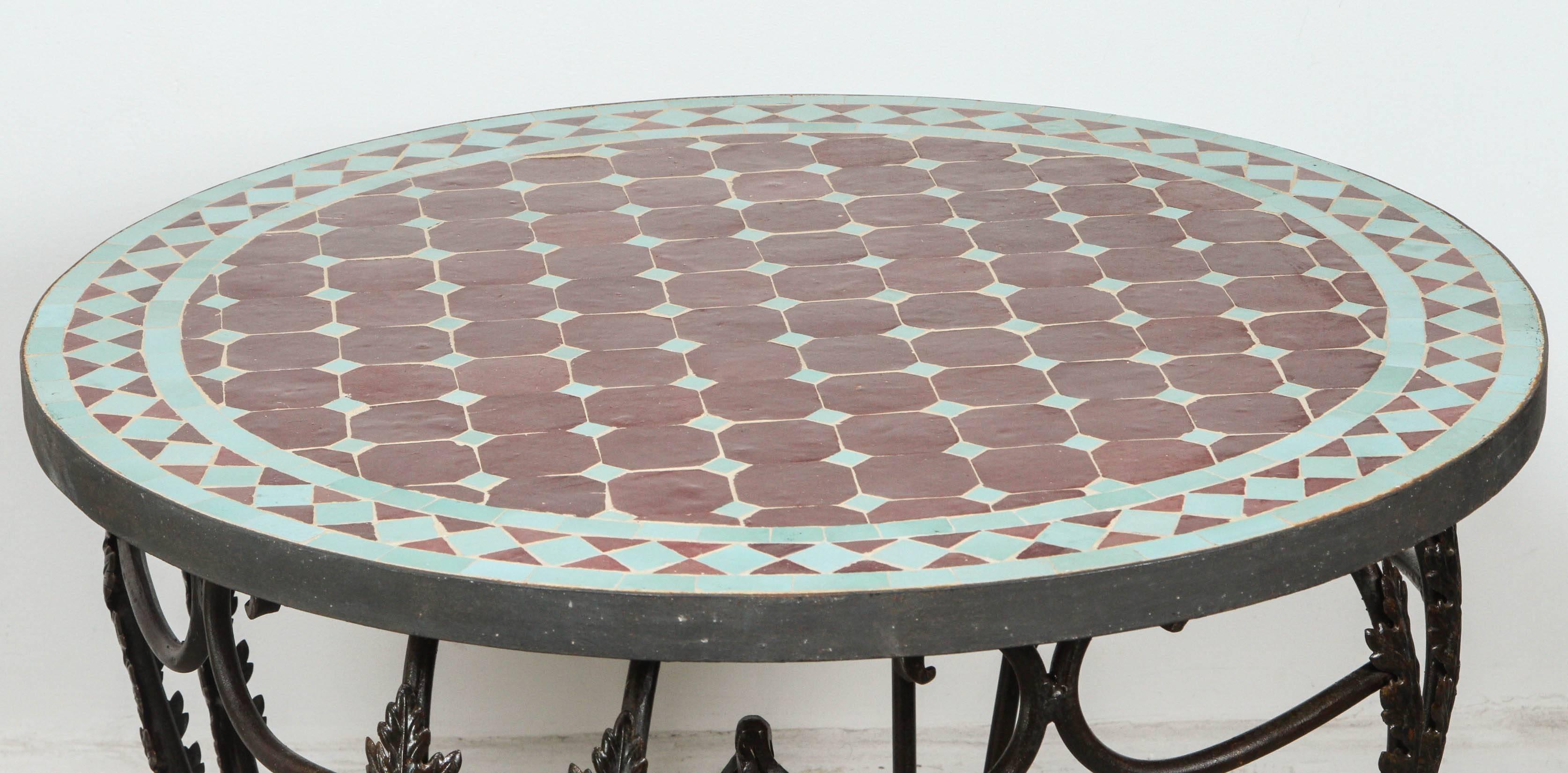 Moroccan round mosaic tile table on low iron base.
Green and burgundy tiles hand cut in geometrical designs.
Hand-made by expert artisans in Fez using reclaimed old glazed tiles and making beautiful geometrical designs, colors are aqua green and