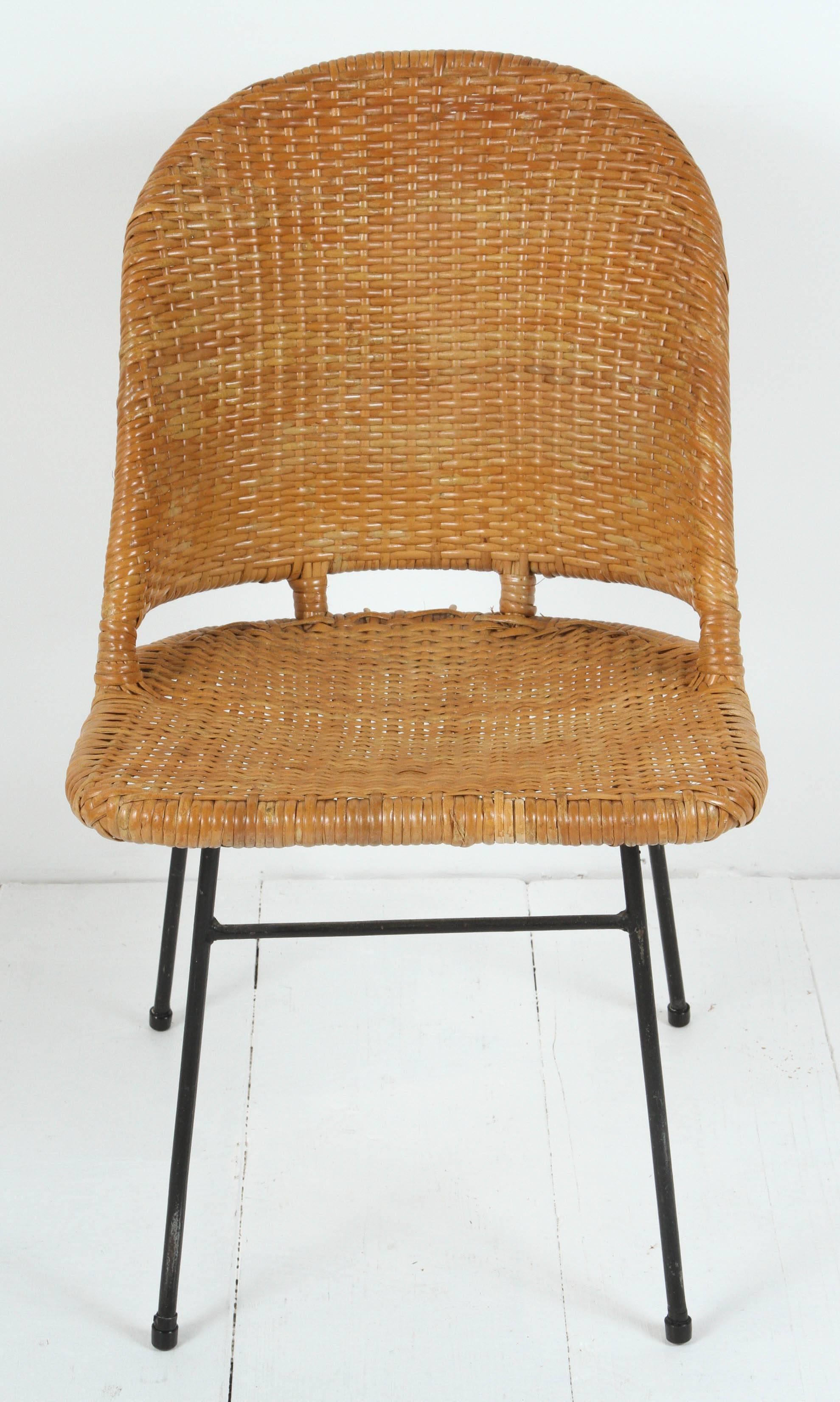 Set of six rattan and iron dining chairs.