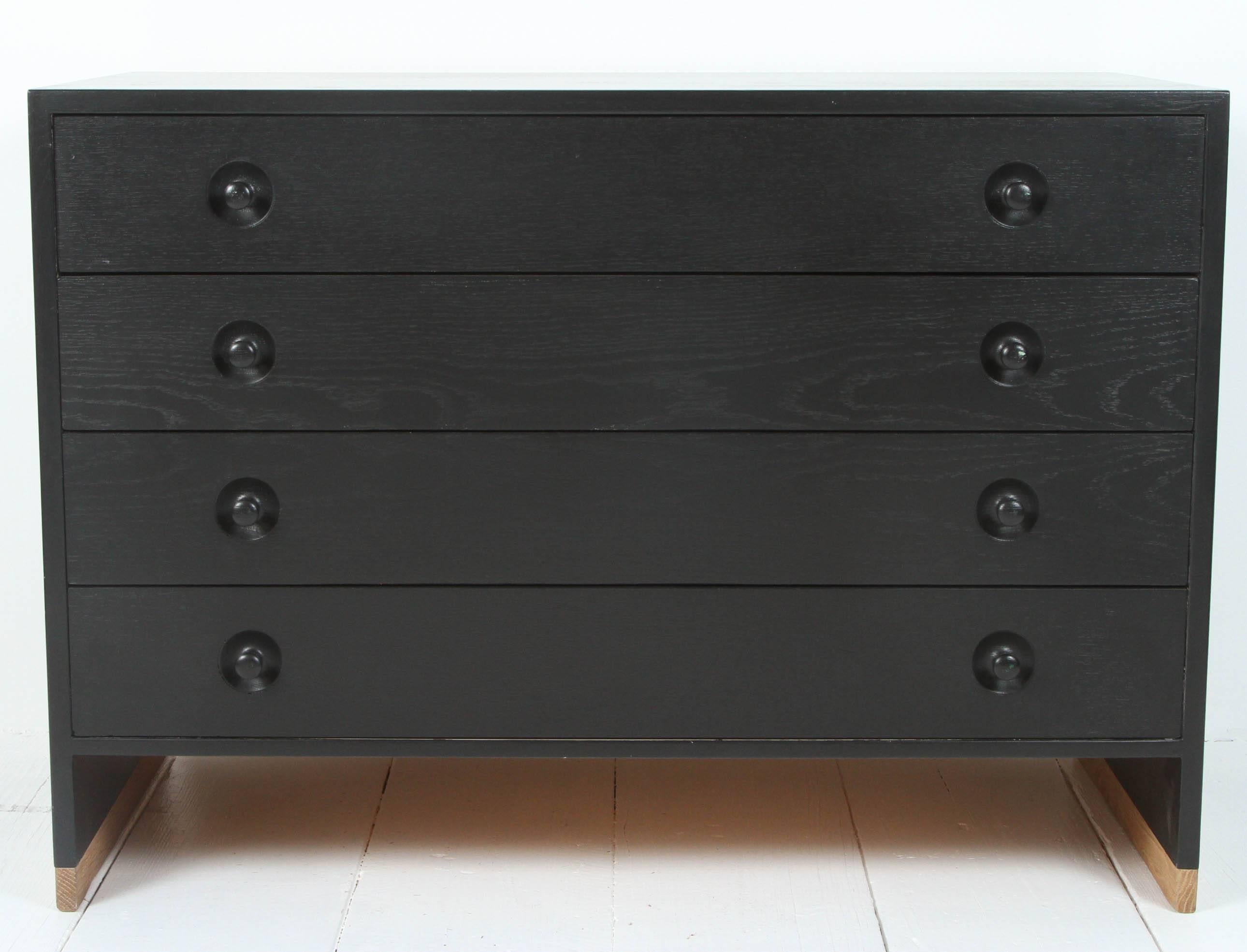 Danish Hans Wegner black four drawer dresser with wood detail at base