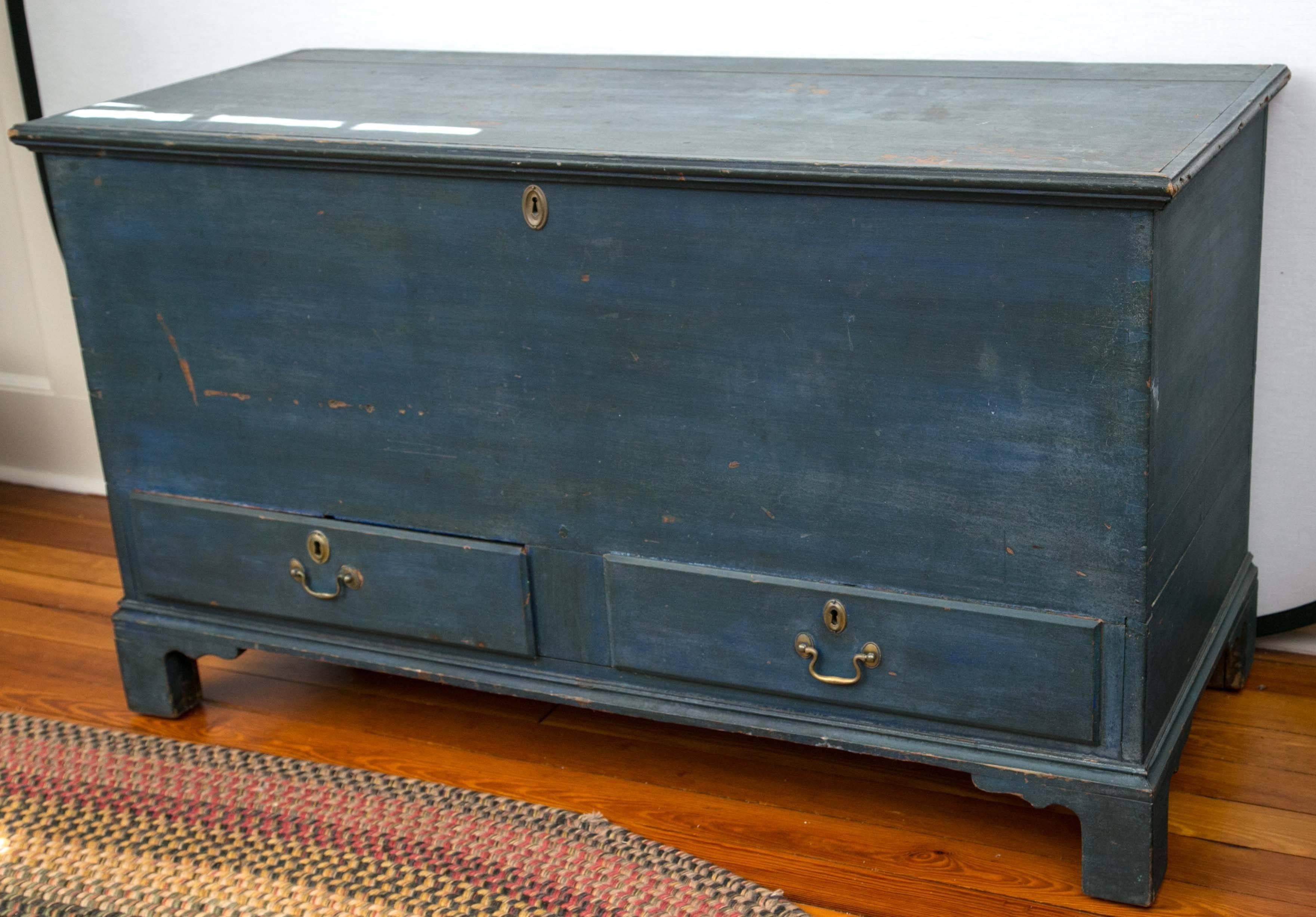 Wonderful Chippendale poplar and yellow pine bracket base, two drawer dovetailed blanket chest in great early dry blue painted surface featuring original bail brasses and escutcheons and interior lidded till. Great proportions and size. Good for