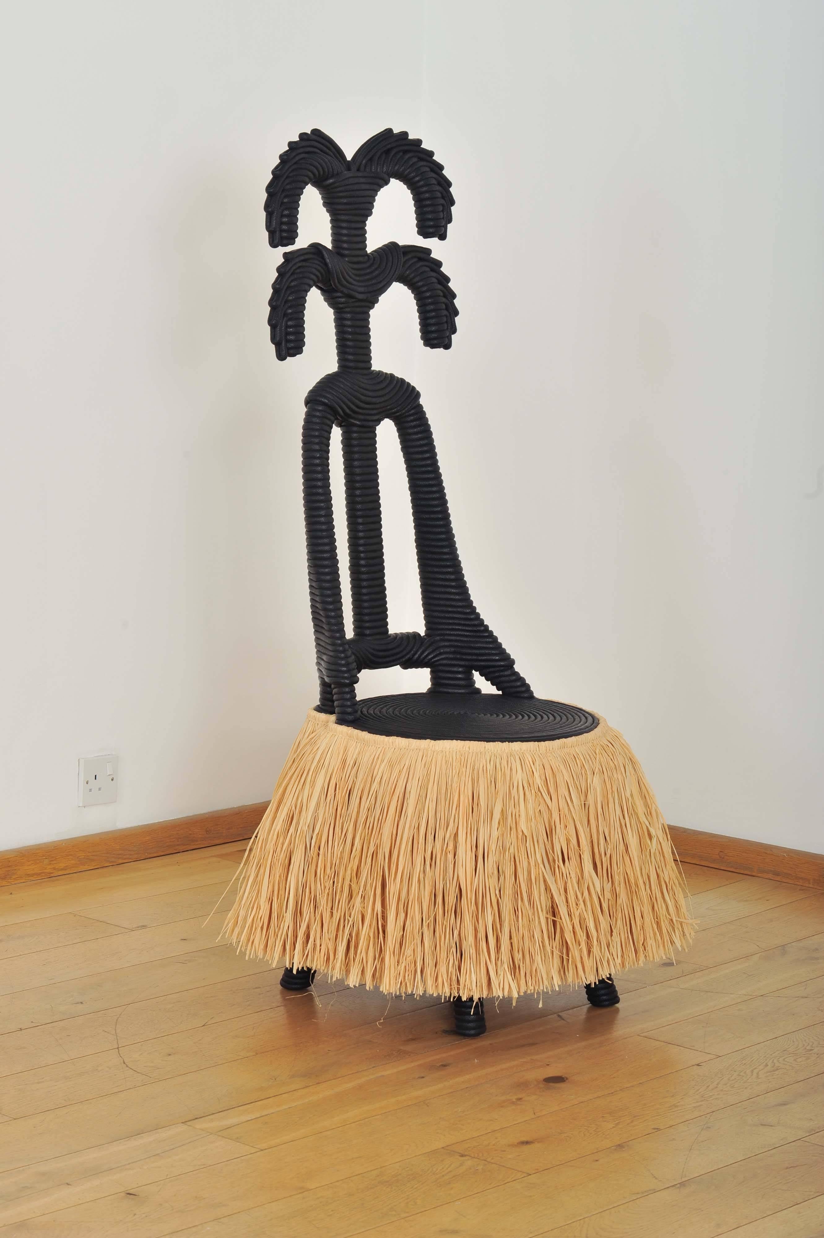 French, contemporary.
African-inspired espresso-brown painted rope chair with natural rafia 'skirt'.
 