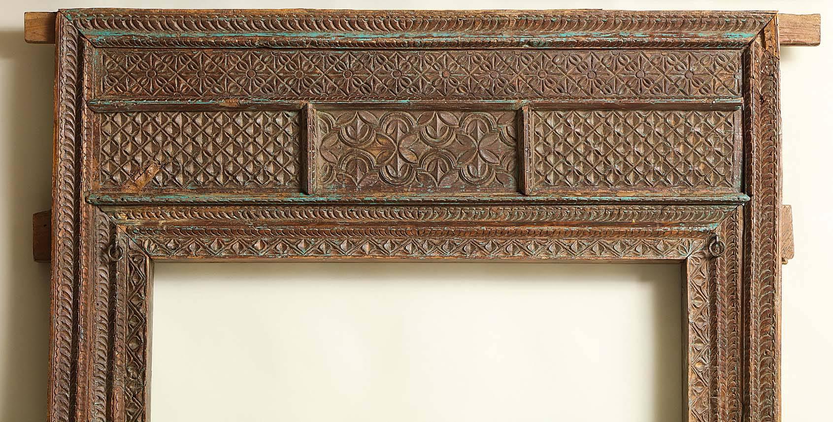 Very good Indian 19th century (or earlier) chip carved doorway with geometric patterns and retaining some original blue pigment, of mitered mortise and Tenon construction which dismantles easily for shipment and storage, retaining a lovely surface