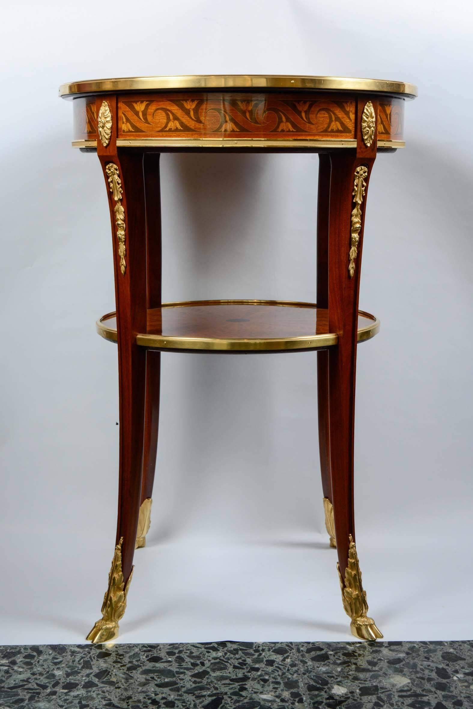 Round gueridon, level - marquetry of precious woods - in the taste of Linke
Ornamented with gilded bronzes.
   