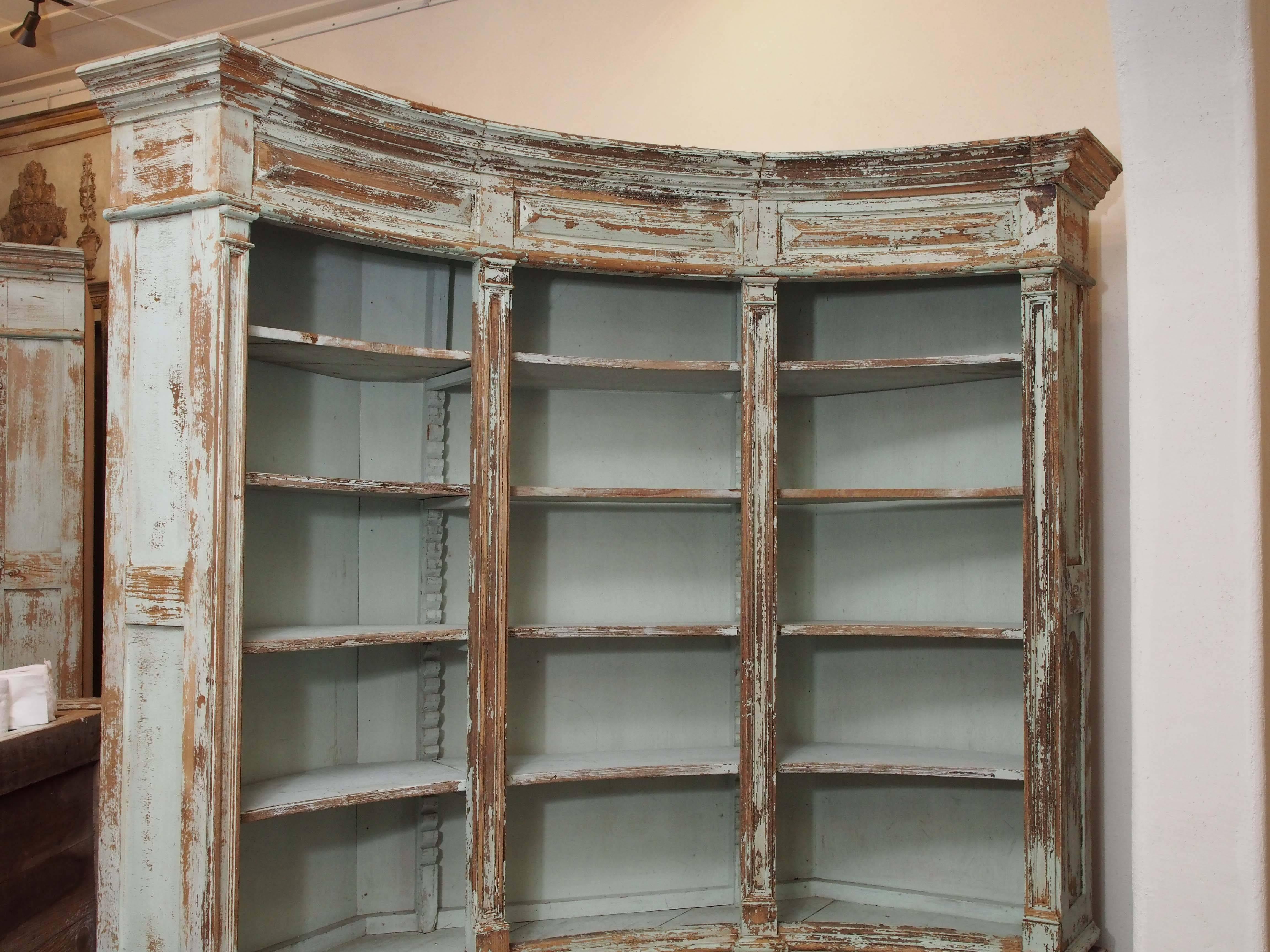19th century French Directoire style hand-painted and handcrafted curved bibliotheque-apothecary cabinet with three drawers, three doors and adjustable shelves. This is one of a pair that is offered separately. These were originally in a herbalist