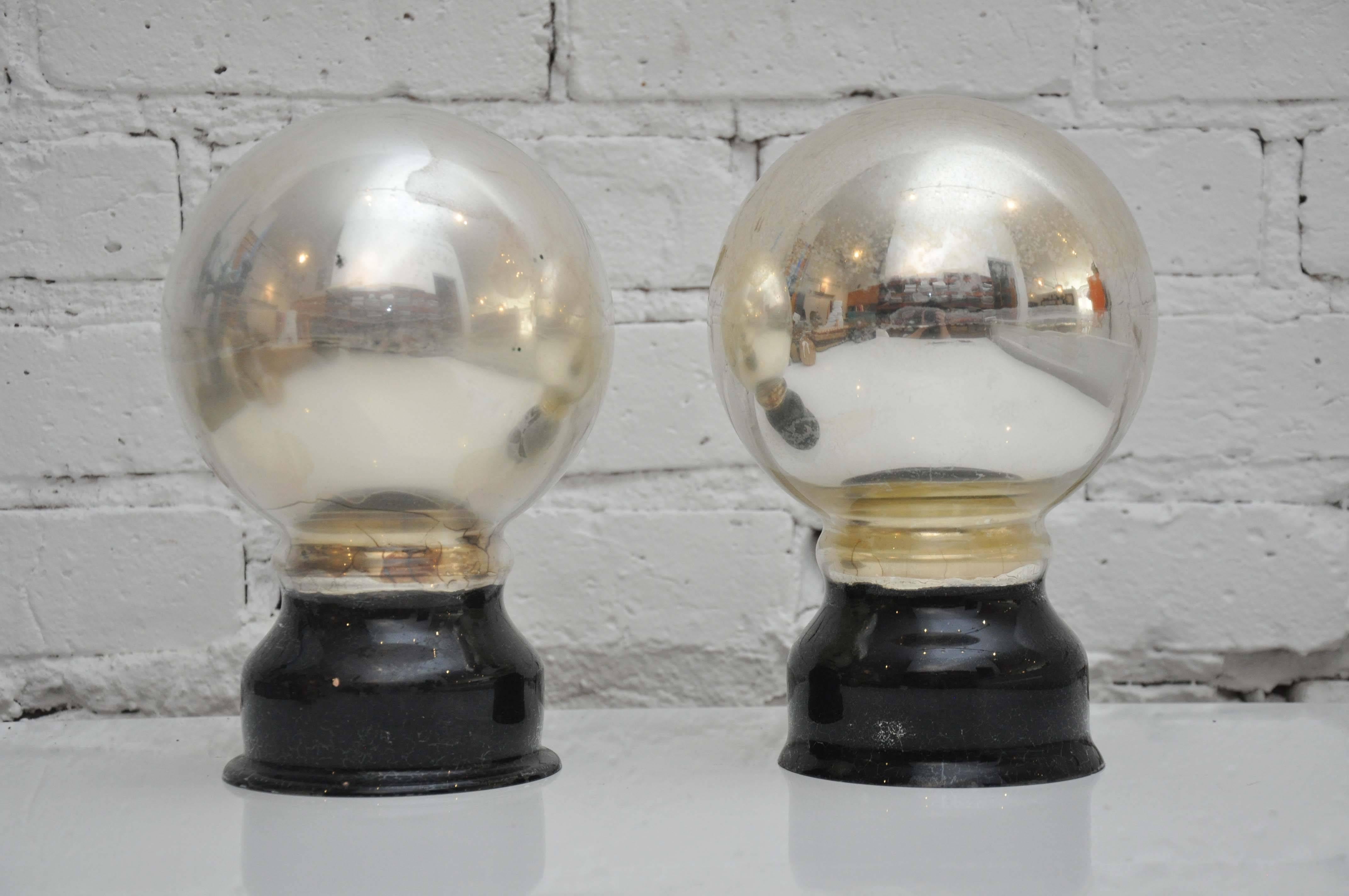 Old and rare pair of Butler's balls, promise they are a thing! Placed on a mantel the Lord or Lady of the house would raise their hands to signal for attention from the Butler who was poised and waiting to notice the reflection in the mercury glass.