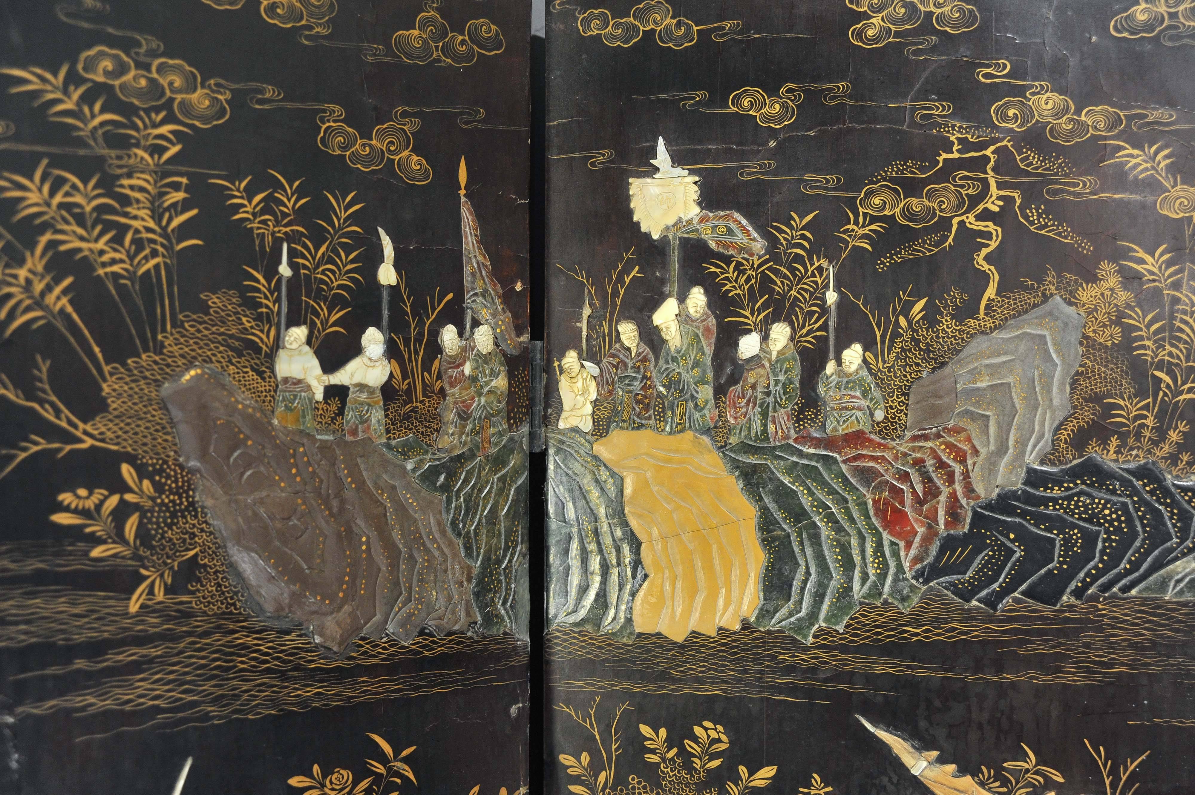 This stunning and intricately detailed 19th century black lacquered Chinese screen depicts a Chinese battle among a variety of mountainous landscapes, tree studies and a wide patterned border. The screen features a variety of semi-precious stones