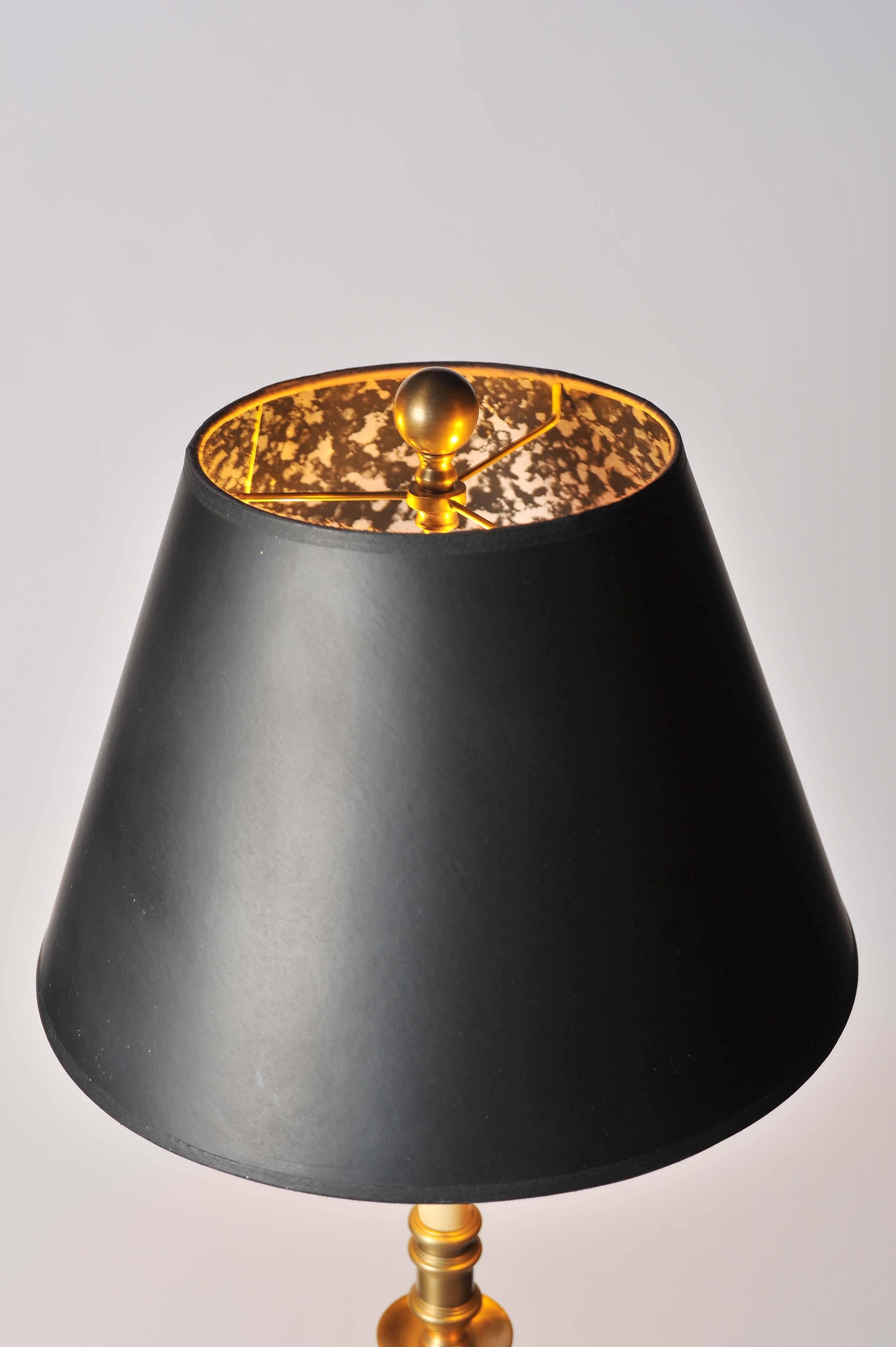 A very elegant brass Chapman standard lamp with a two bulb fitting and painted card conical shade.