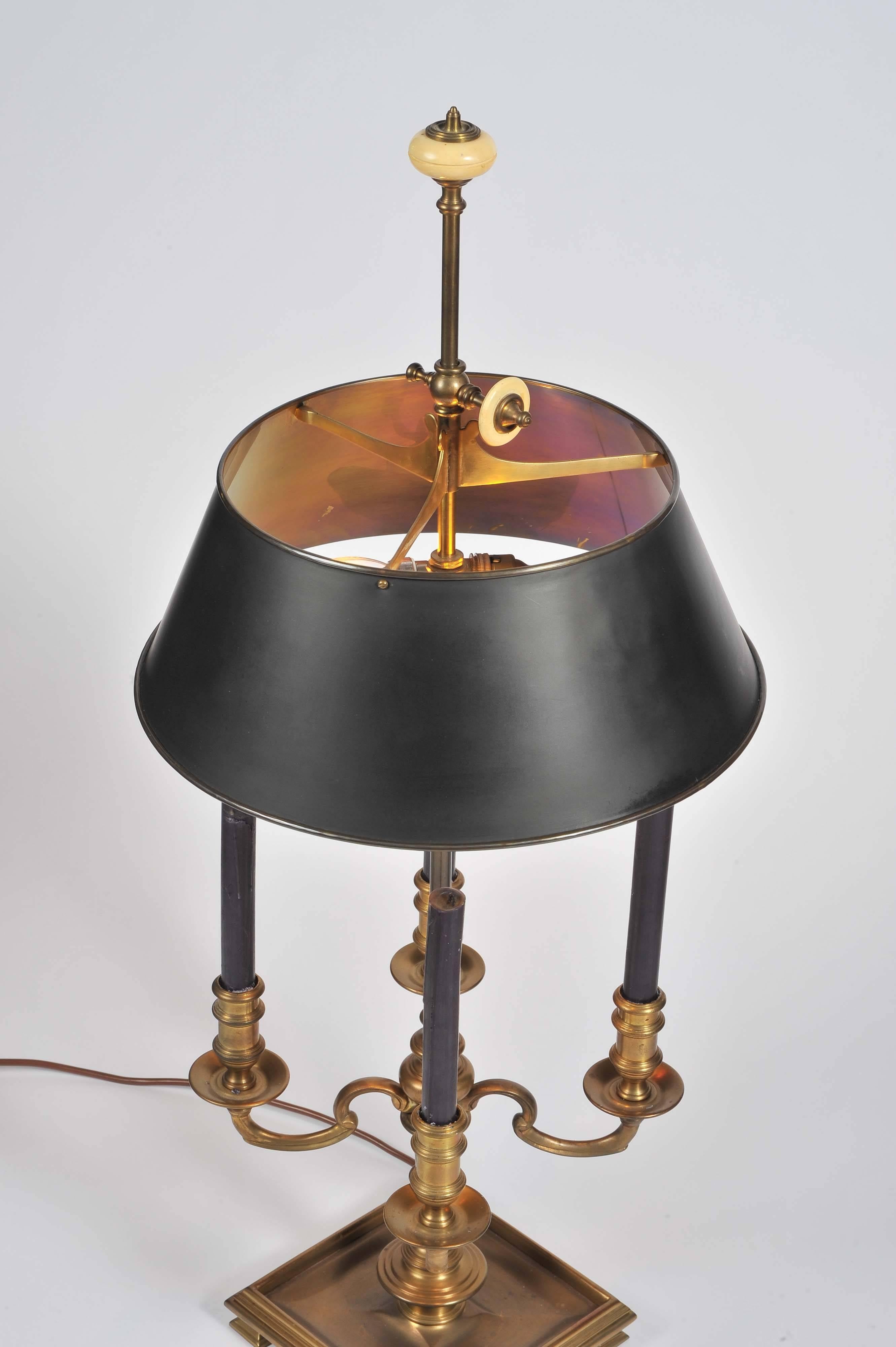 An elegant four branch brass Bouillotte table lamp with height adjustable toleware shade and fittings for two bulbs. The brass a very subtle antiqued finish.