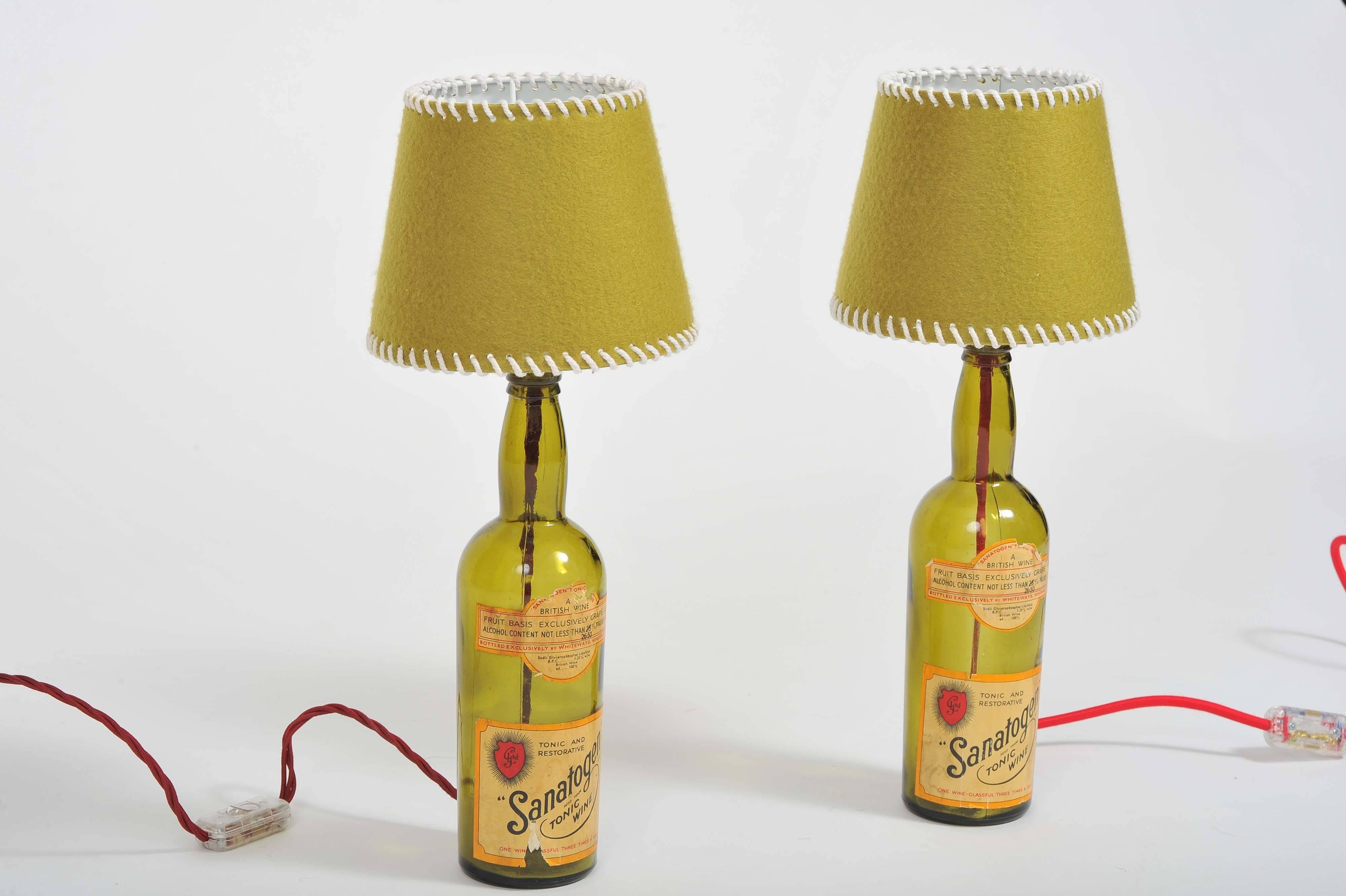 A pair of  1940s Sanatogen vintage handmade rustic style glass bottles table lamps, Redesigned to be decoratives table lamps. 

Made by Joelle Talmasse. 
