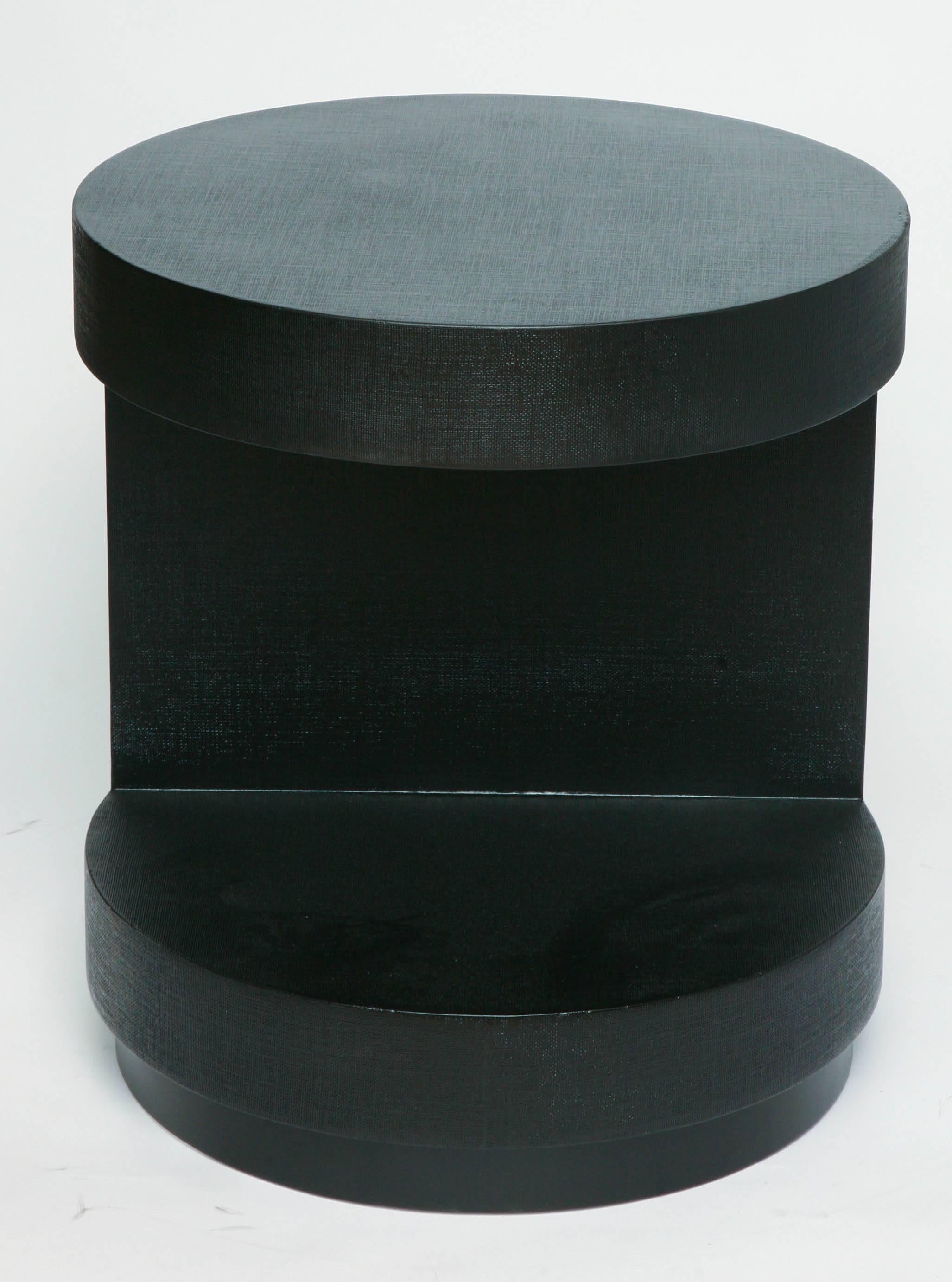 Raffia covered black lacquered two-tiered end table attributed to Karl Springer.