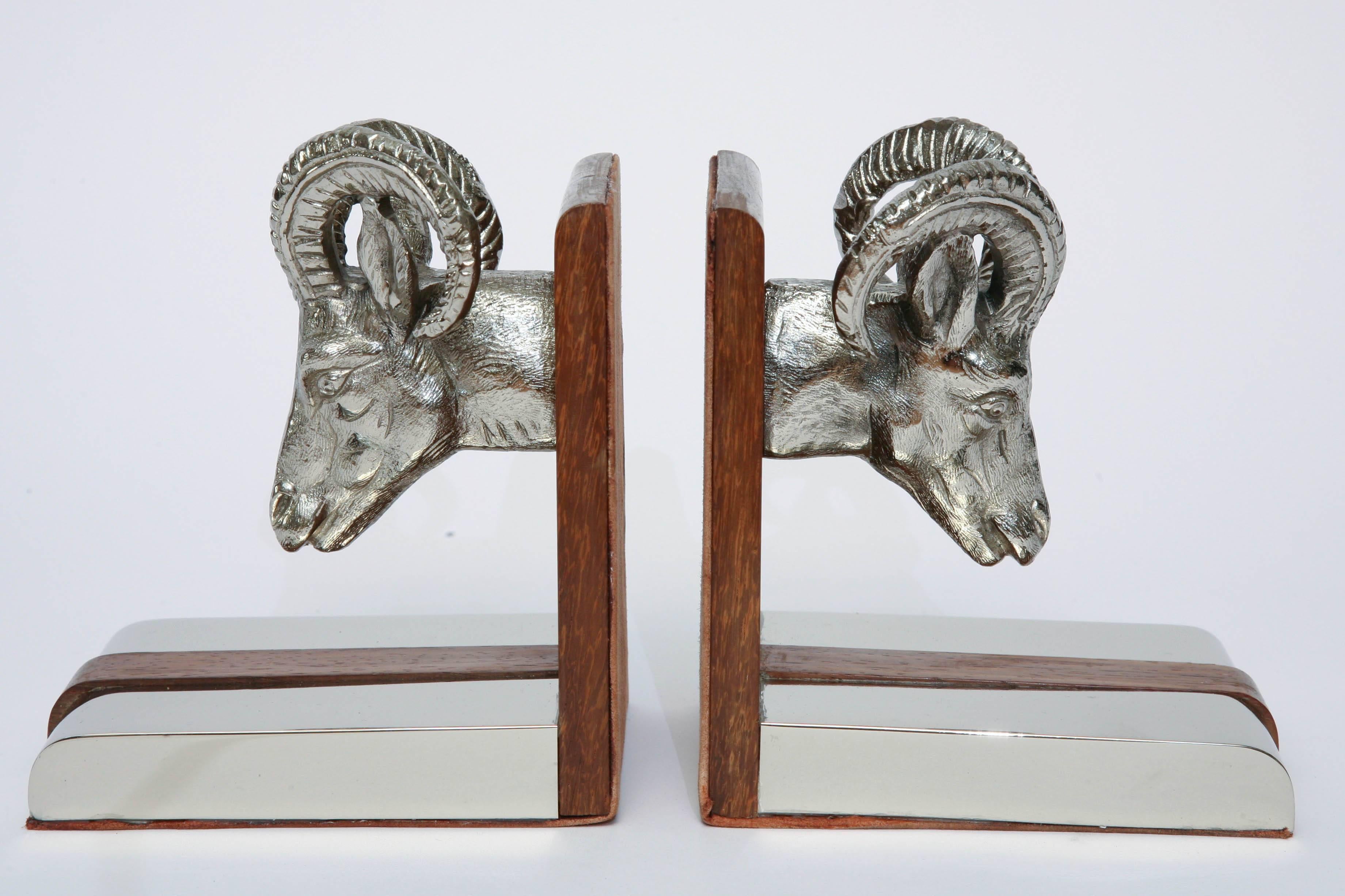 Striking pair of chrome and wood ram's heads bookends by Gucci.