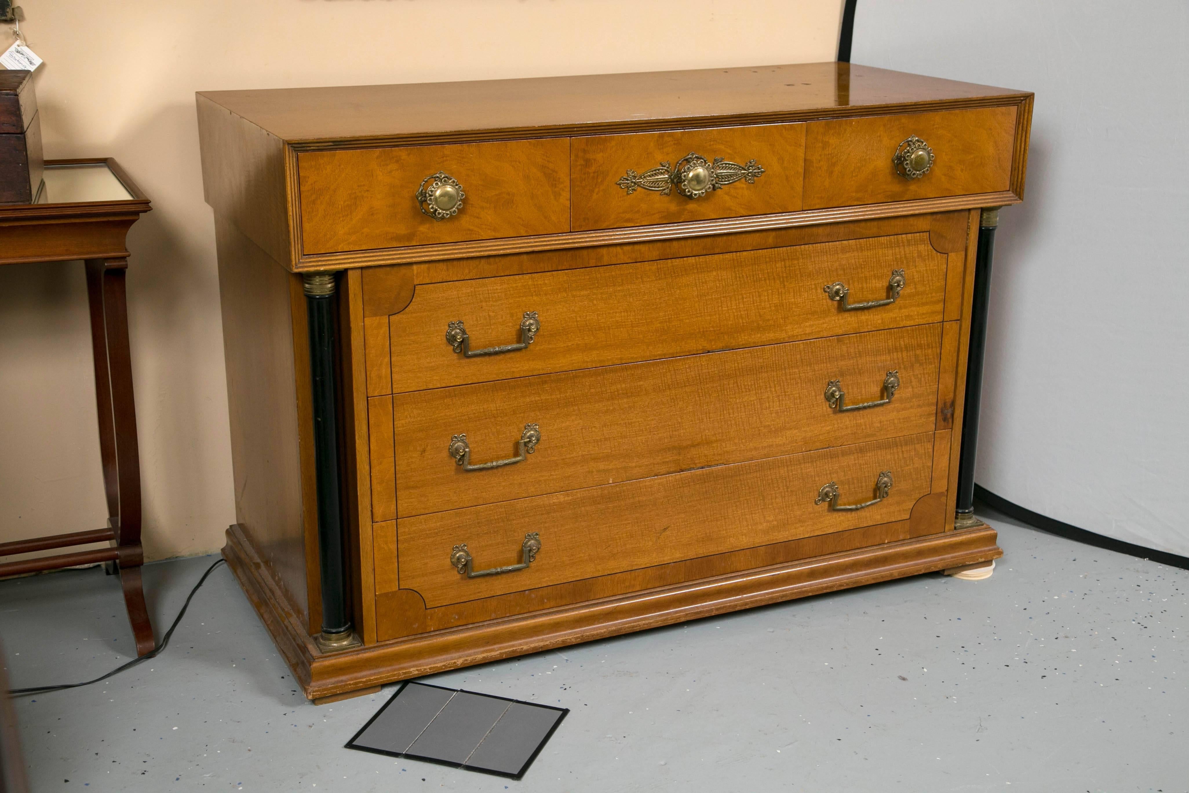 A pair of Bethlehem Biedermeier style column front six-drawer chests. Each with a molded bracket base supporting four rows of drawers three larger drawer under three smaller drawers flanked by ebonized column sides having bronze-mounted tops and