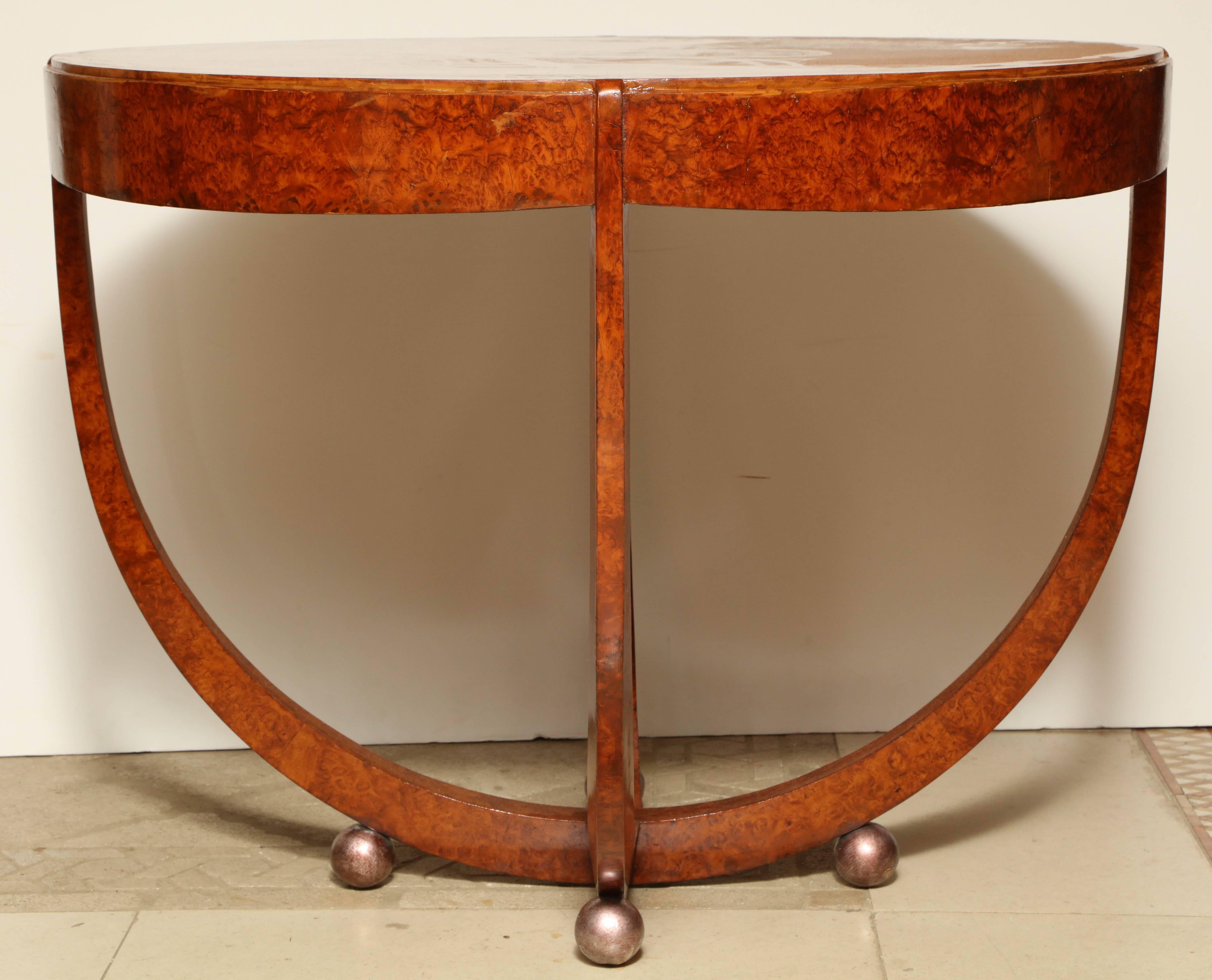 An unusual Art Deco burl inlaid round center table with unusual floating base on ball feet.