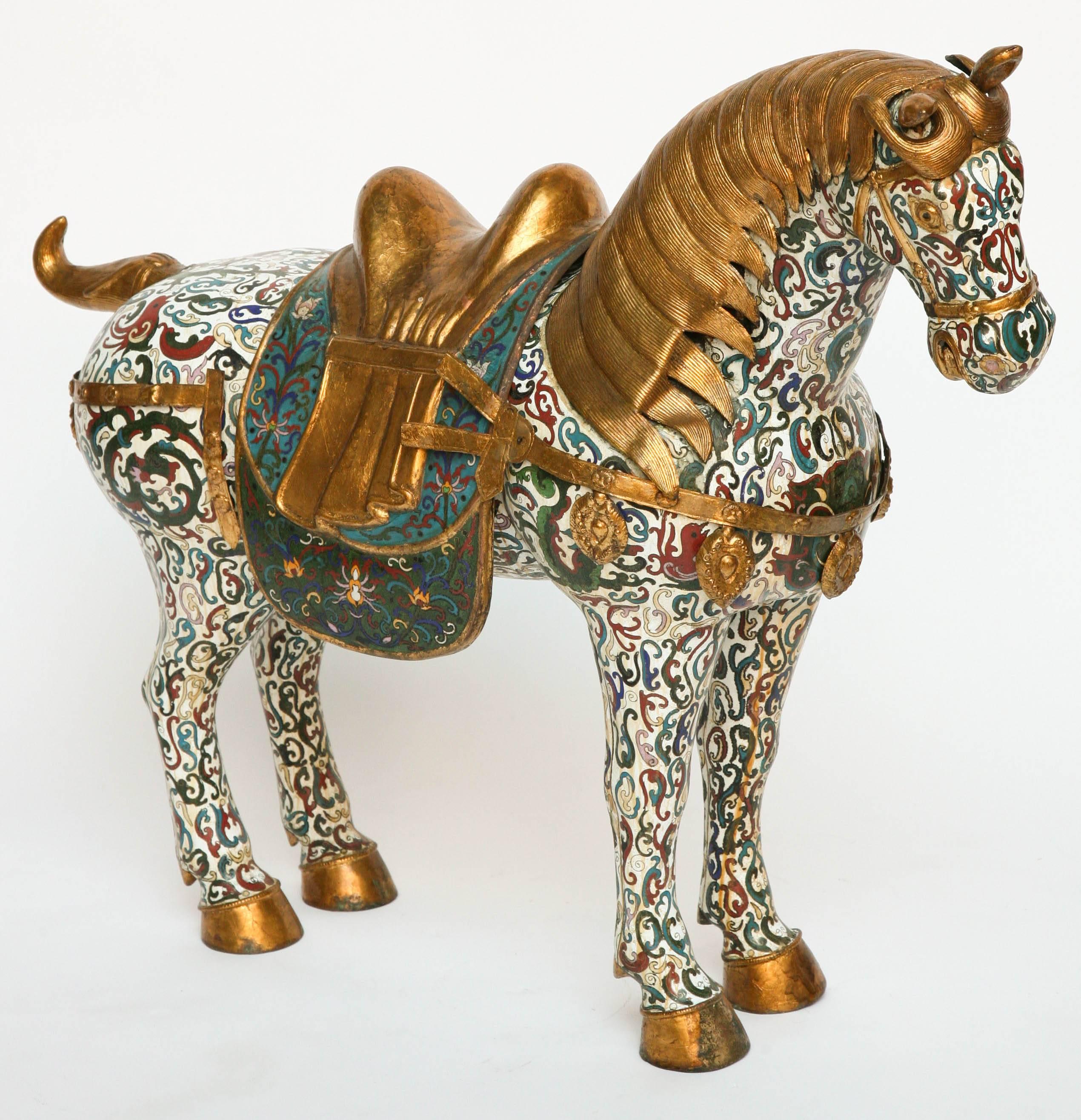
The figure is classically posed and fitted with a gilt metal saddle.
The cloisonné inlay is extensive and elaborate. Important and dramatic size.
    