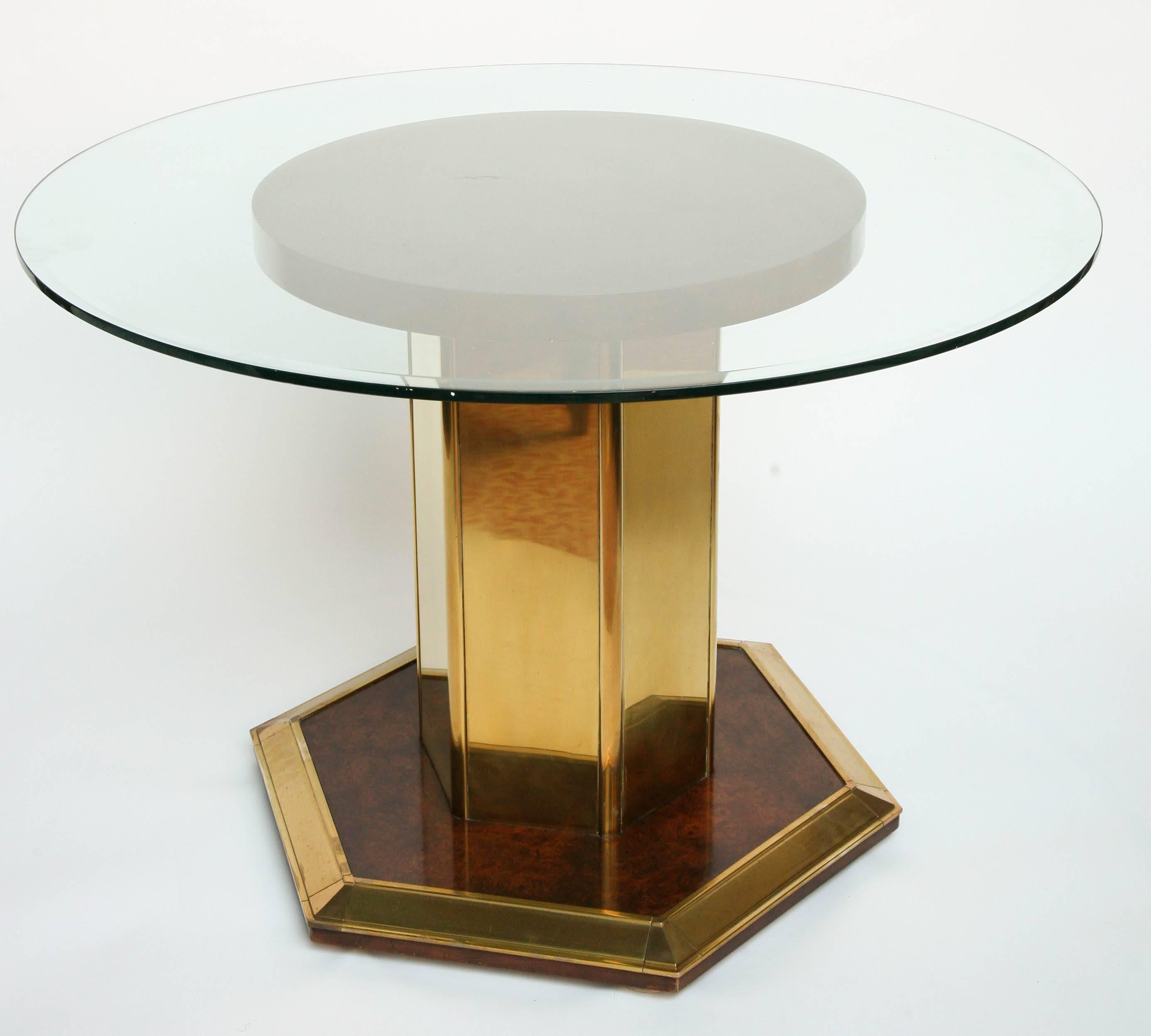 Six-sided base and pedestal in brass with burled wood appointments. Glass top is 44" diameter.