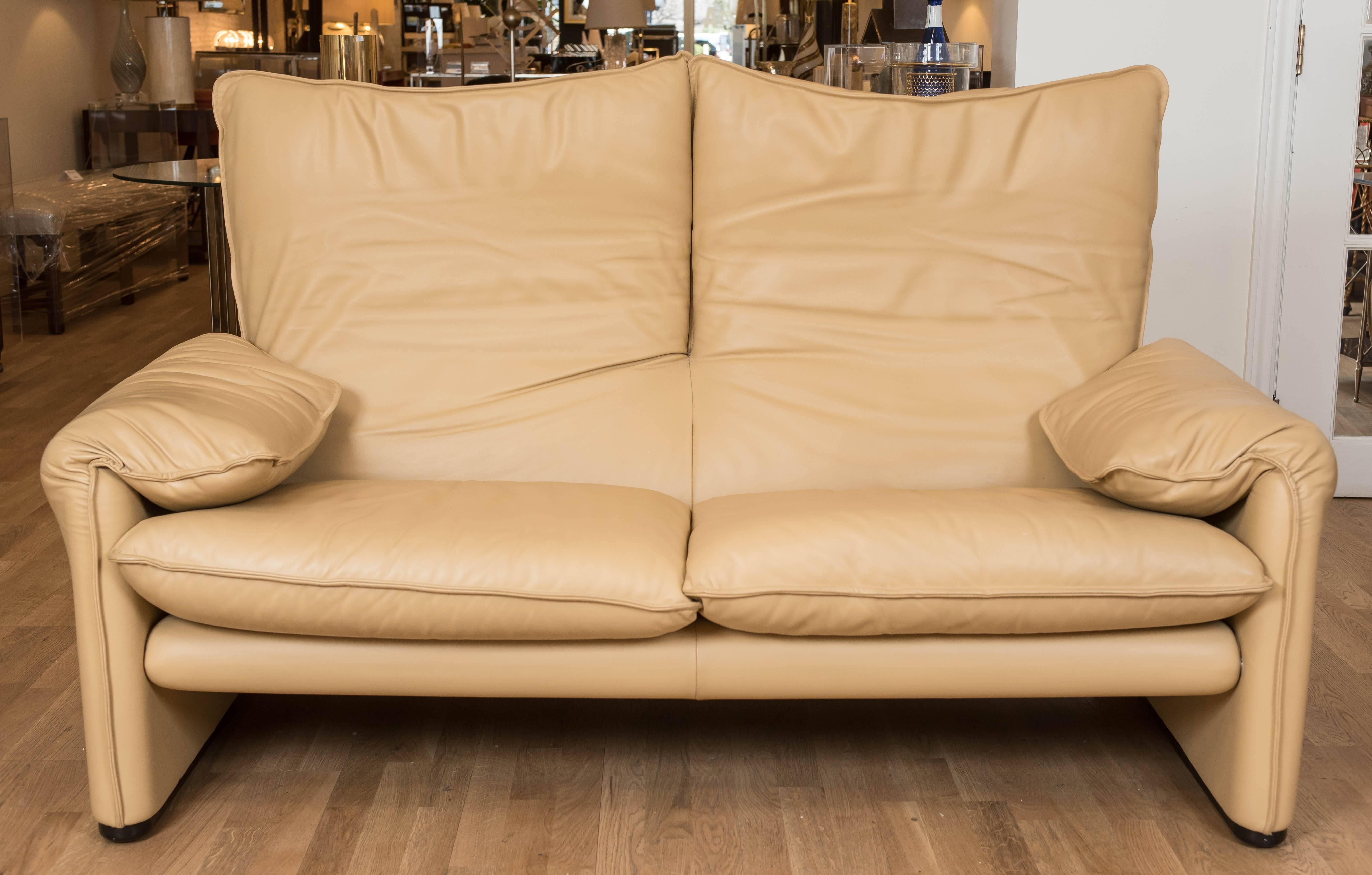 This sumptuous 1973 designed Maralunga two-seat sofa has been recently reupholstered in a "cafe au lait" colored executive leather. This Classic sofa is never out of style and built to last by world renowned furniture maker Cassina.