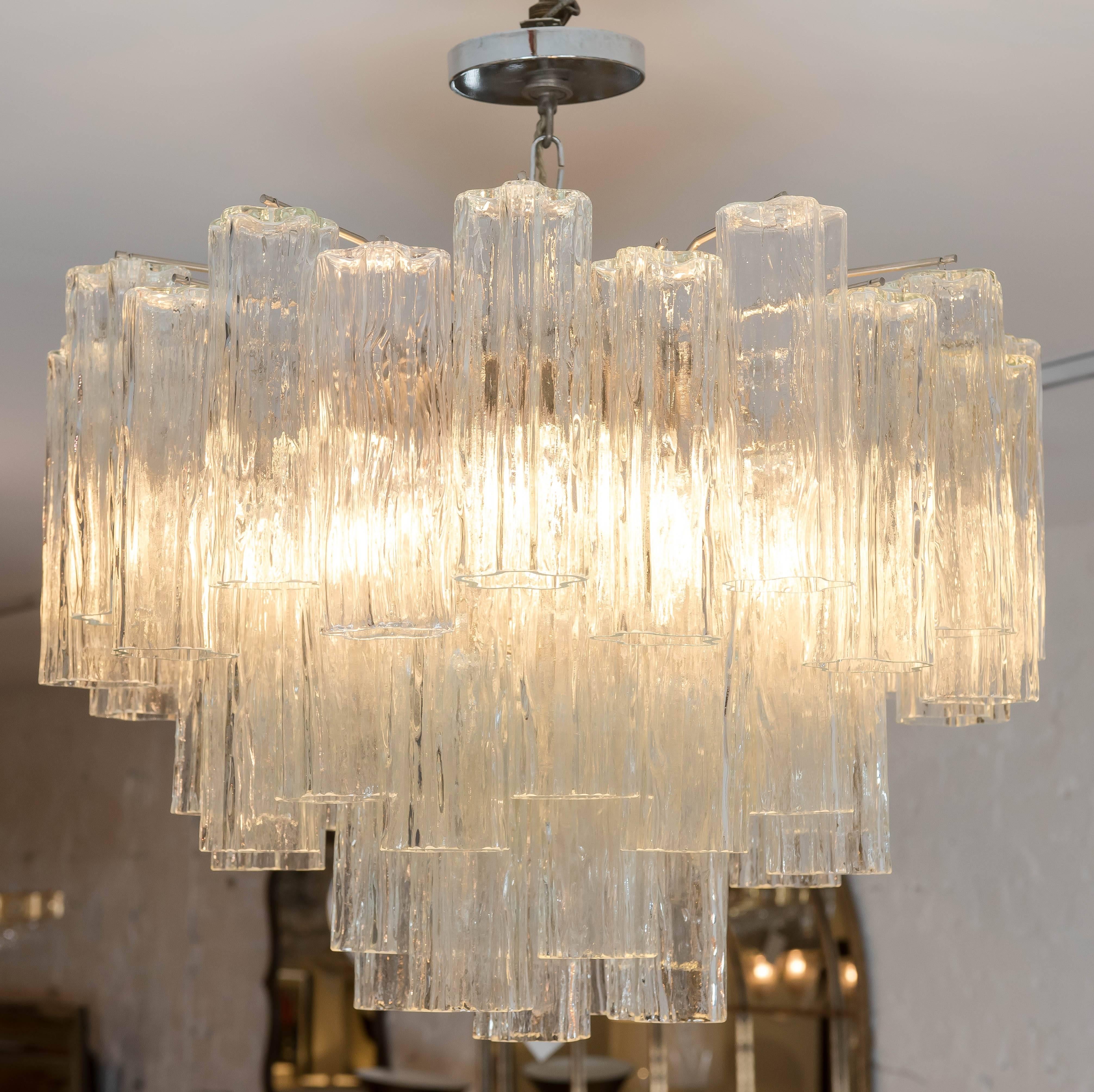 This grand yet simple cascading tronchi glass six light pendant is
in excellent condition. There are no chips or breaks in the glass and the frame is made of steel. It is wired for North America and ready to install.
     