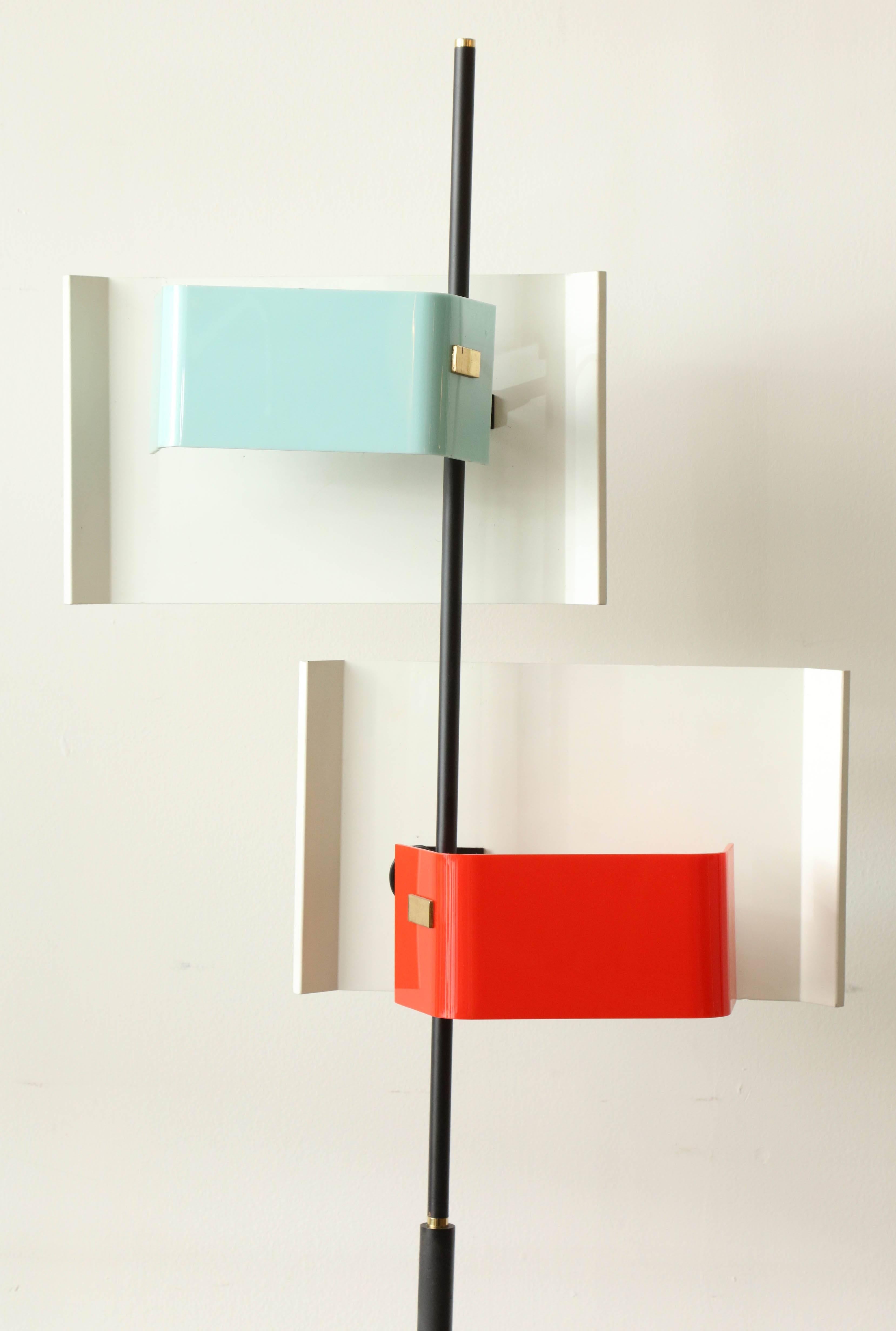 Exciting tall floor lamp made in Milan 1955 by Stilnovo, signed, two lights with red and pail blue Perspex shades on a lacquered brass and marble base with the original floor switch, rare form, takes two e14 bulbs.
 