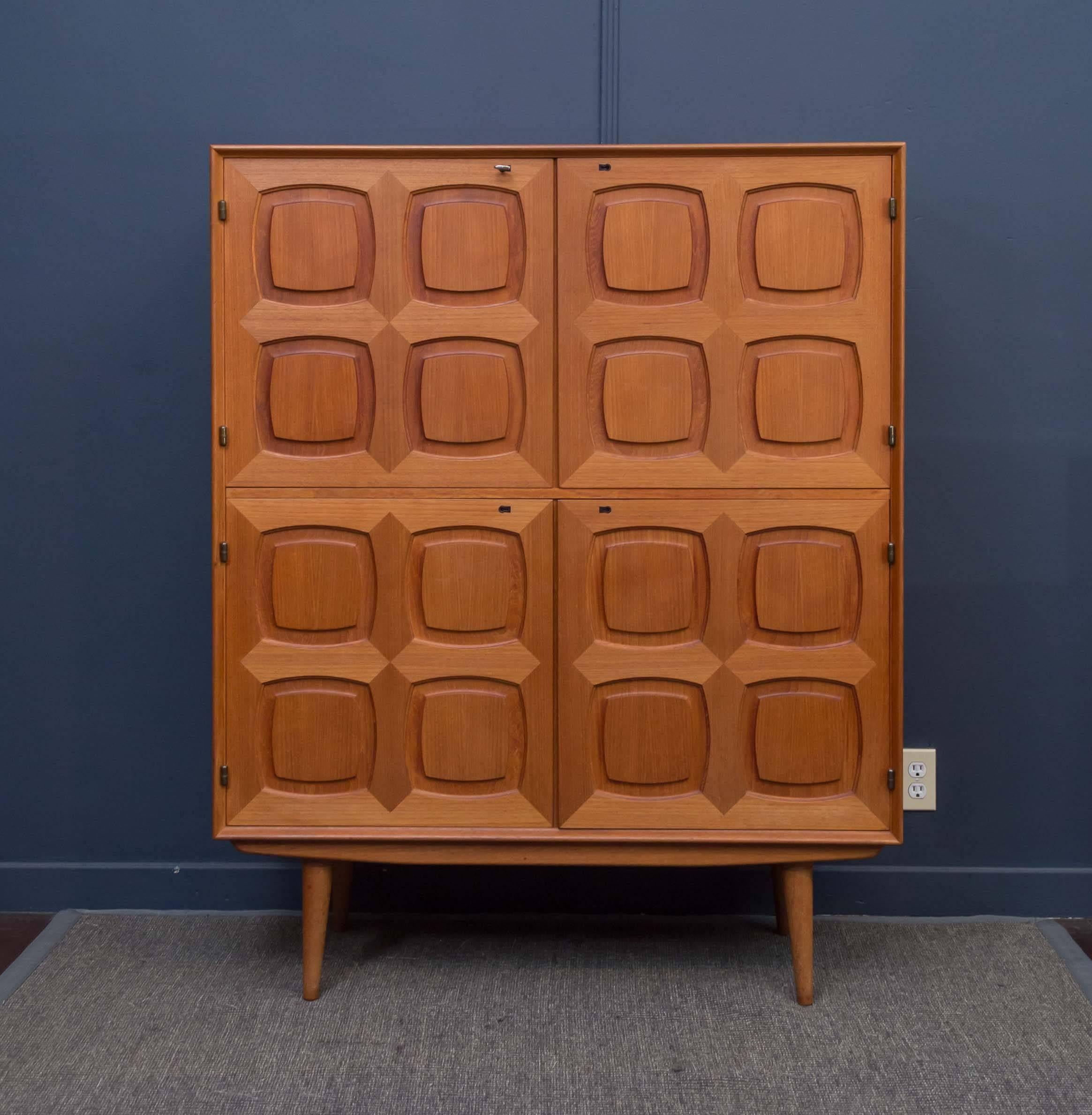 Scandinavian Modern four door cabinet designed by Adolf Rastad and Rolf Relling for Gustav Bahus Norway, designed in 1960s. Handcrafted teak wood doors with individual locks and adjustable shelves. Excellent original condition.