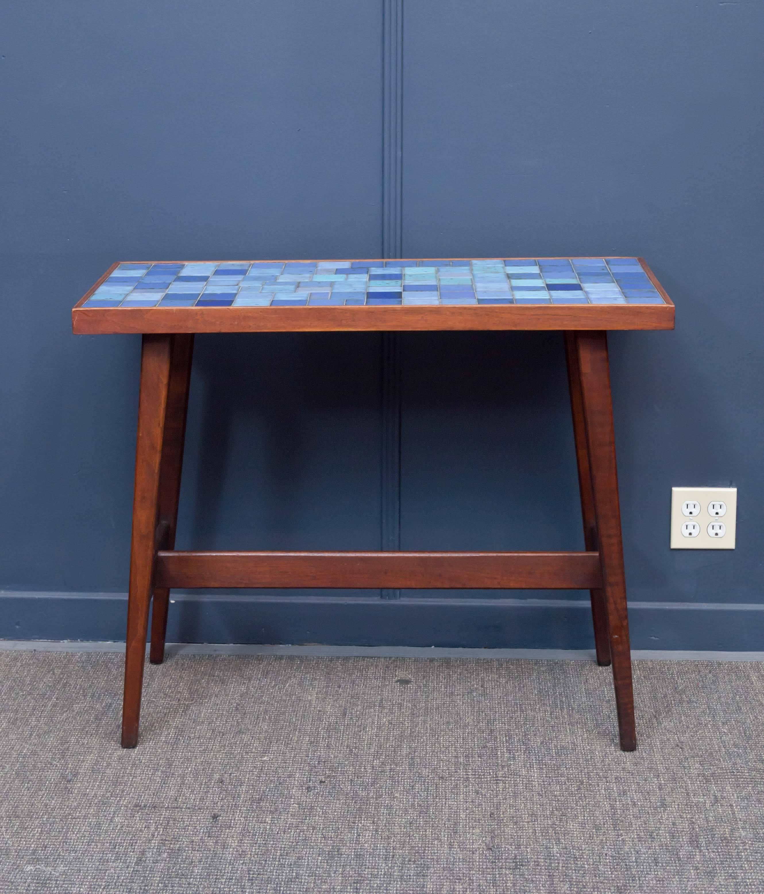Wonderful console table in serene shades of blue tiles and framed in black walnut. 
Well executed in high quality materials, excellent vintage condition.