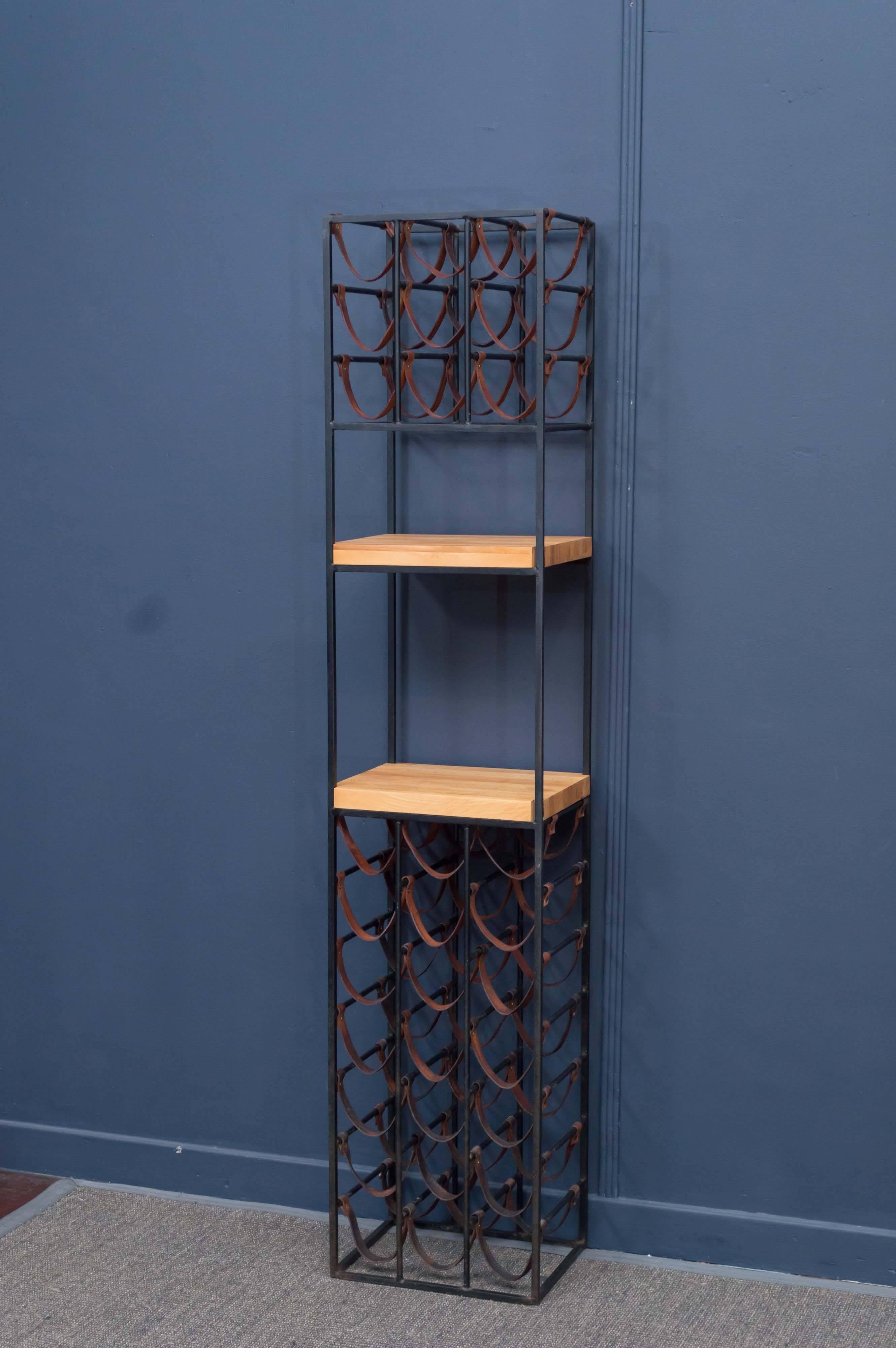 Arthur Umanoff design wine rack with two refinished cut boards and all original leather strapping.