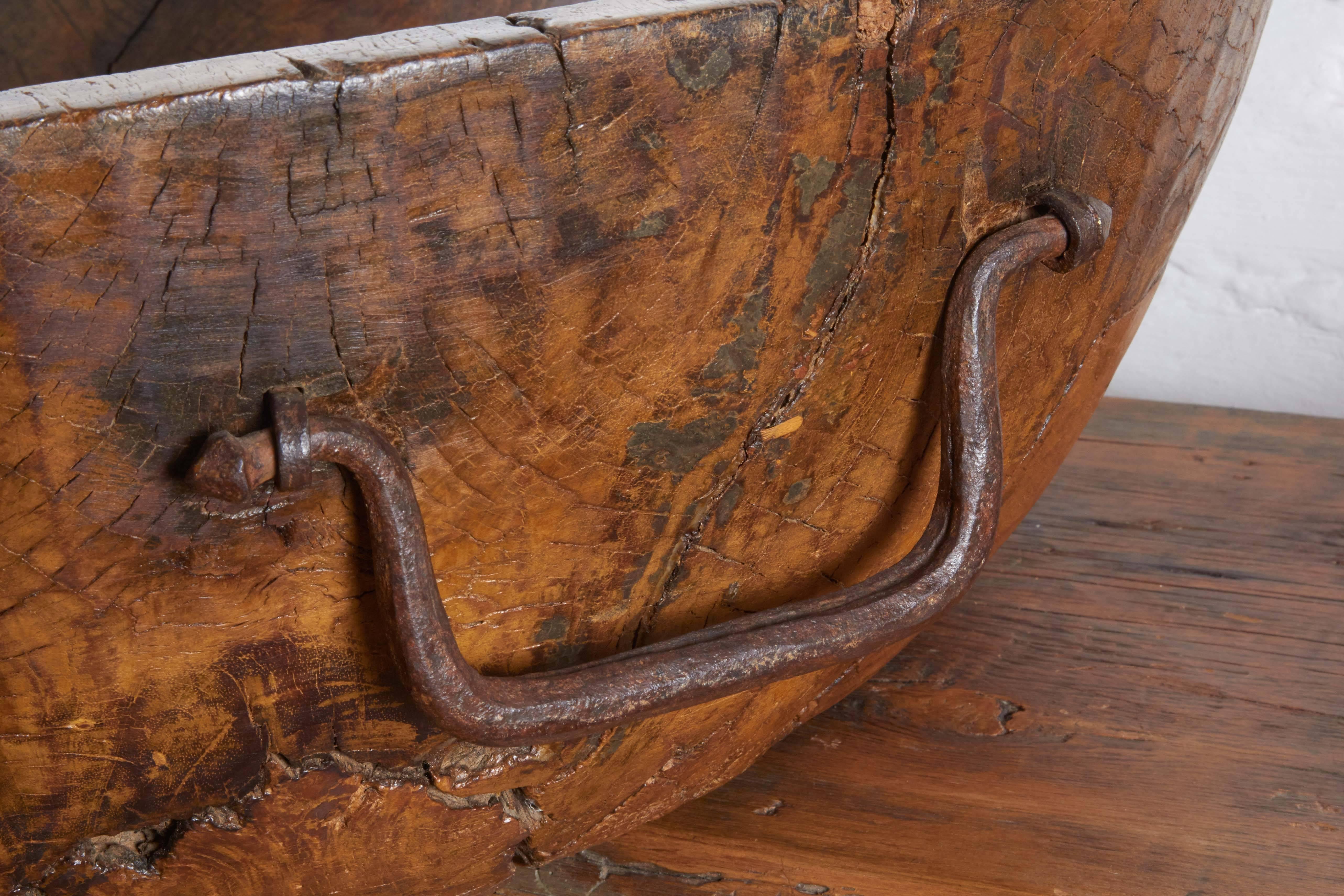 Early 1800s, used in monastery for bread, hand pounded iron handles, carved from solid piece of black walnut.
 