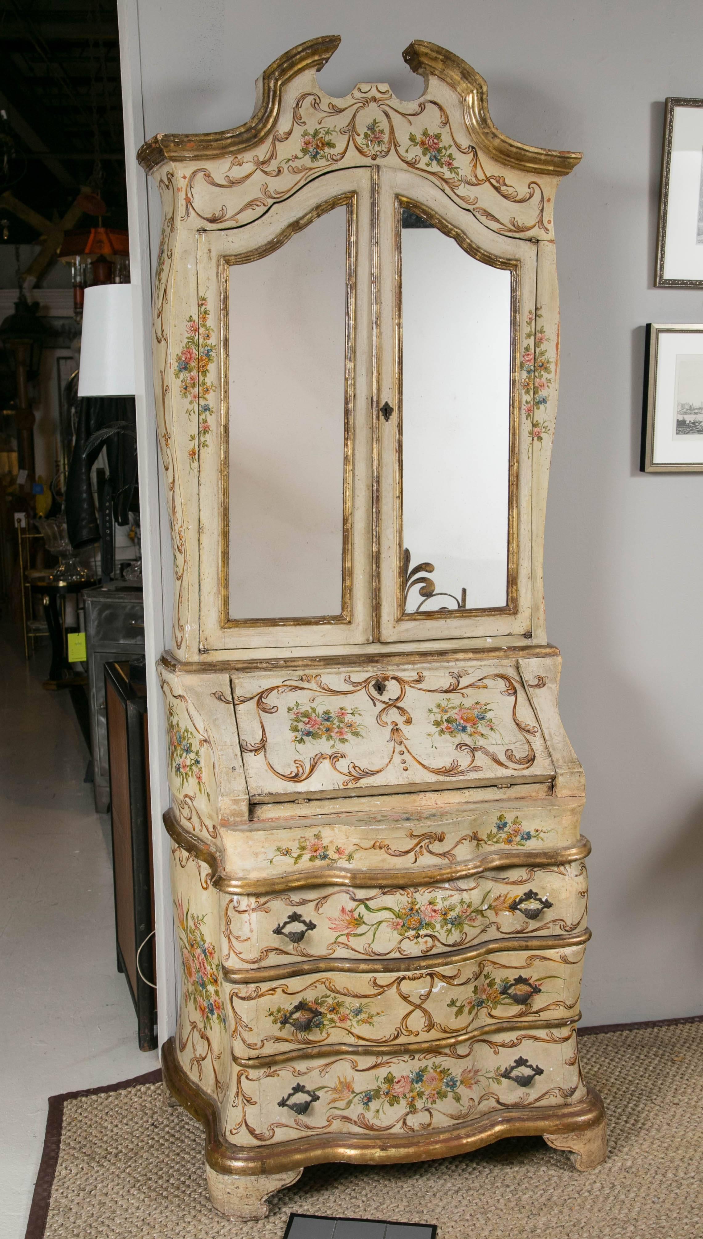 Antique hand-painted Venetian secretary. Two pieces. Original hand-painted condition with gold gilt details. Original mirrored doors on the upper cabinet. Interior cabinet lined in red damask with two removable shelves. Original key to desk,