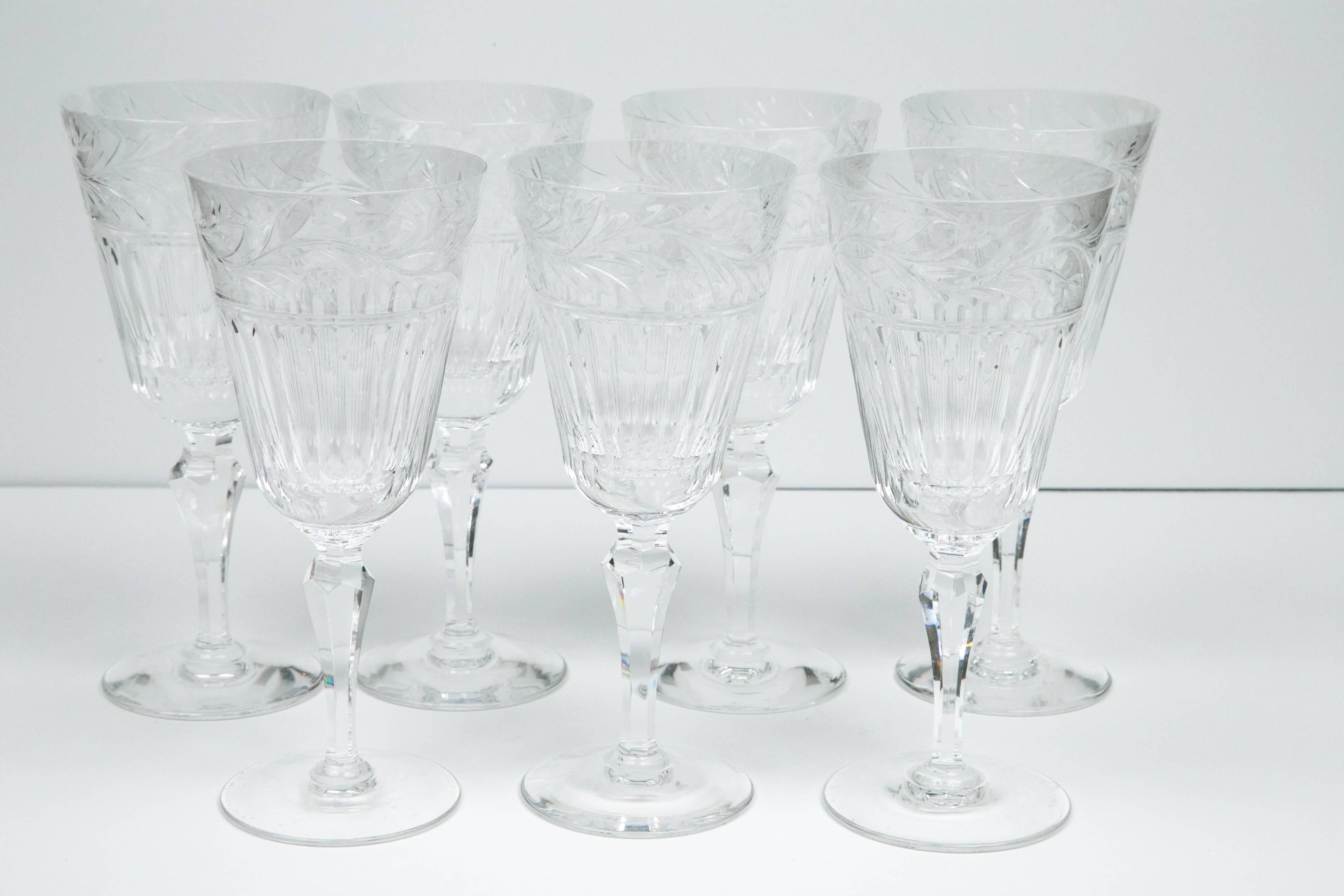 A set of seven crystal glasses by Asprey. Featuring cut crystal with a leaf pattern encircling the rim.