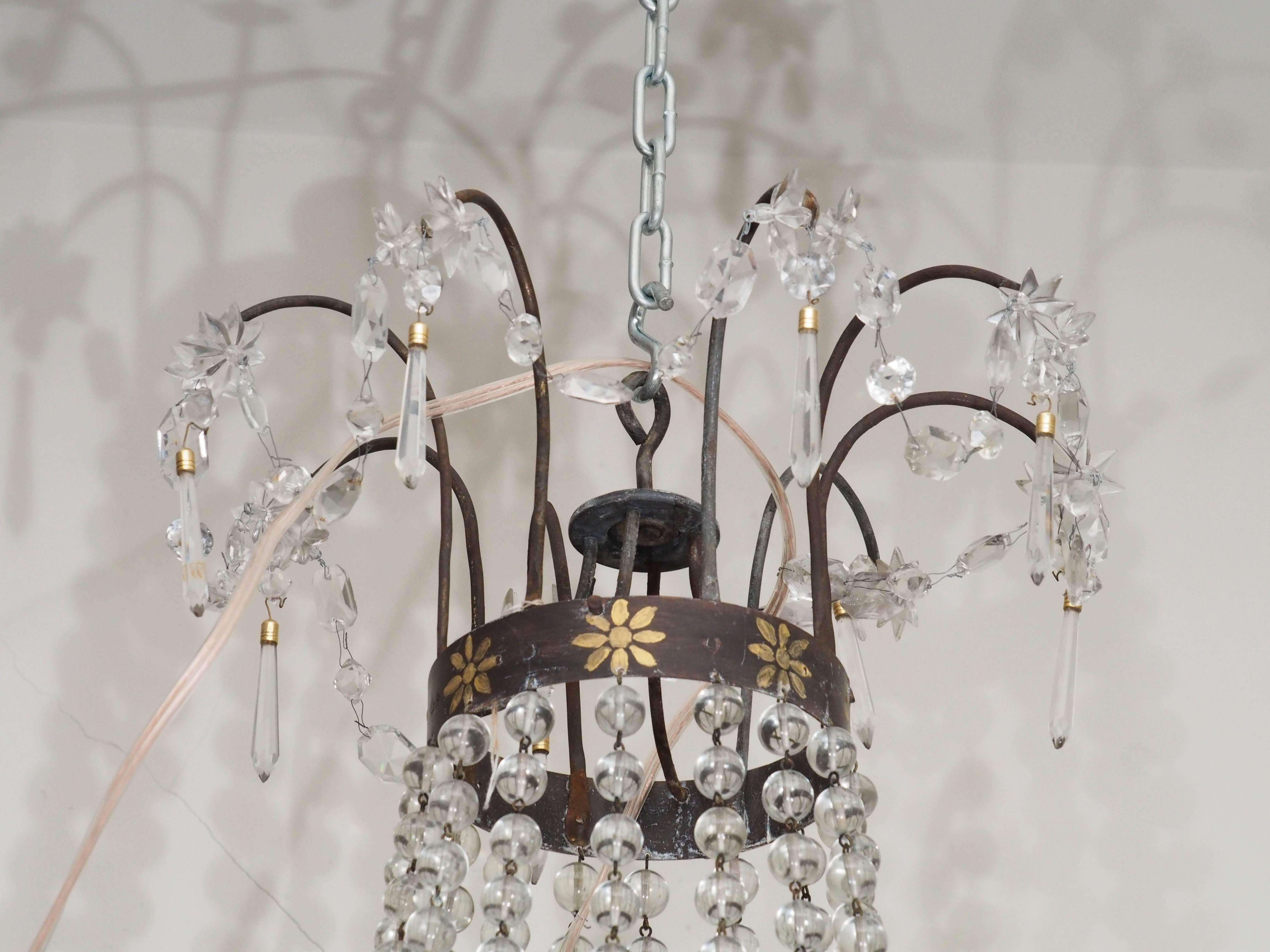 Italian Empire tole chandelier with crystal dressing and gilt decoration, eight arms.