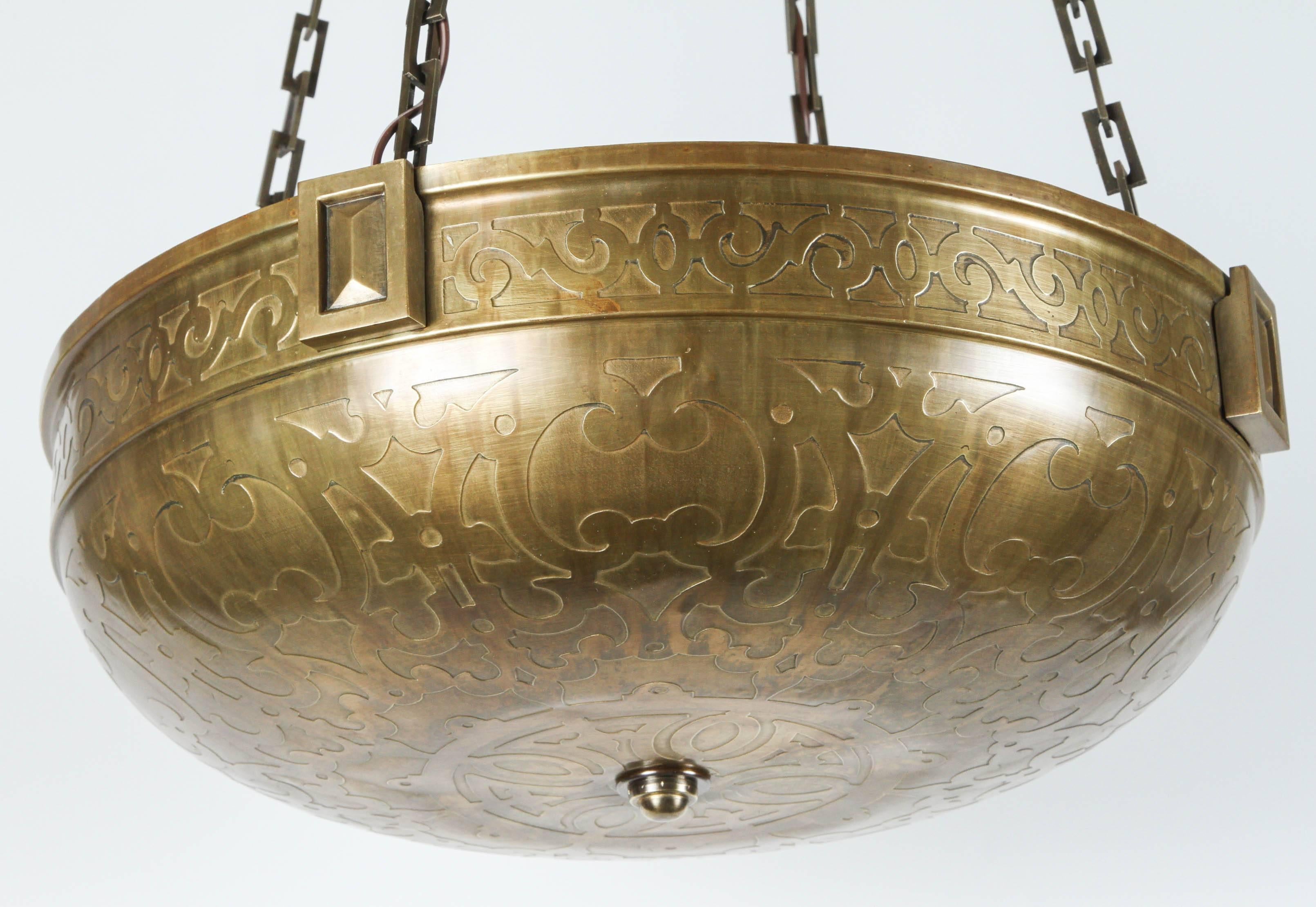A larger Moorish-style early 20th century acid-etched brass bowl fixture. Exceptional quality. Measures 19.5in diameter.  New electrical up-lit four (4) Edison base, new chain and canopy. Total drop height is 43 inches.
   