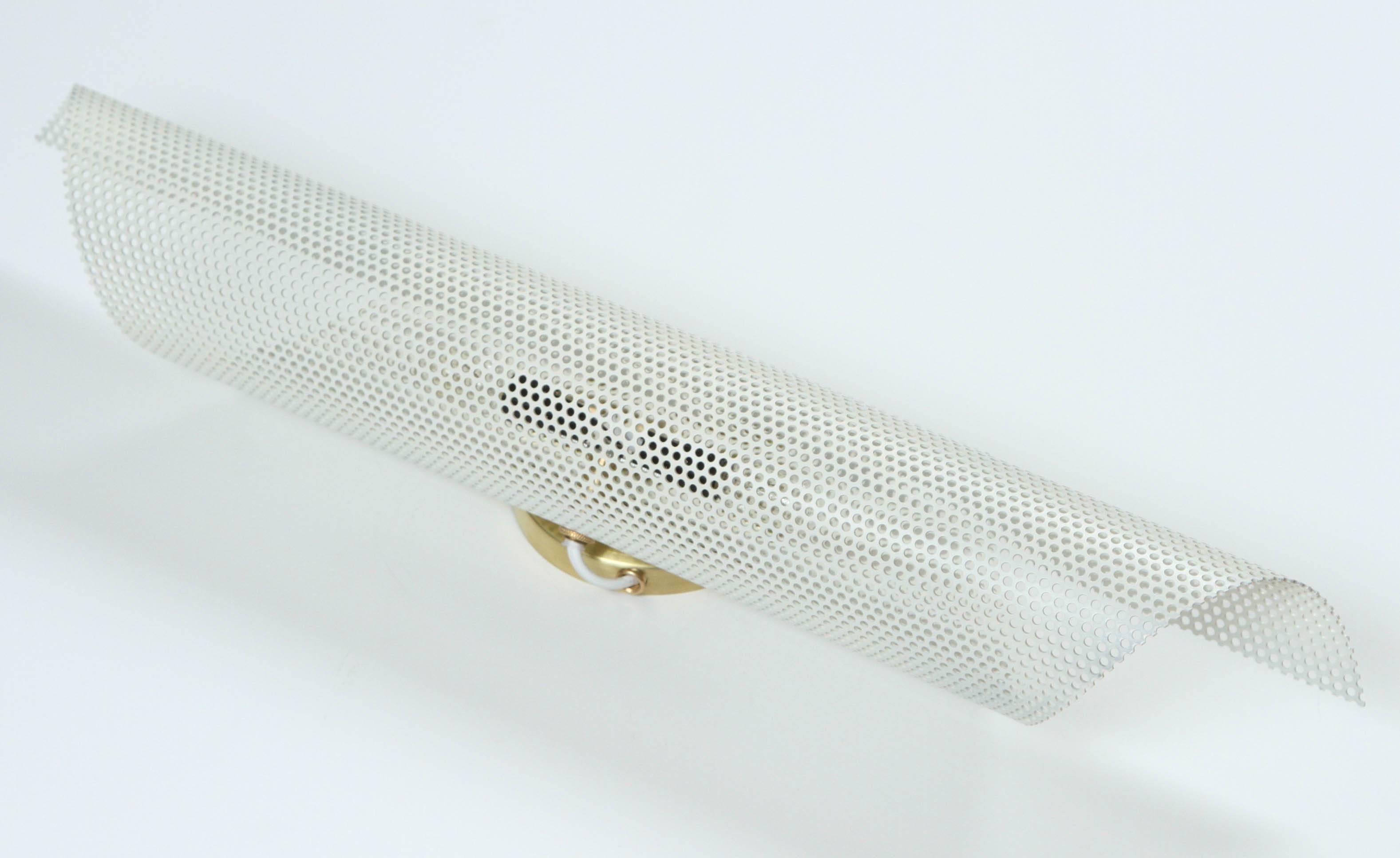 Rolled perforated sconce by Lawson-Fenning.

Available to order n white or black.