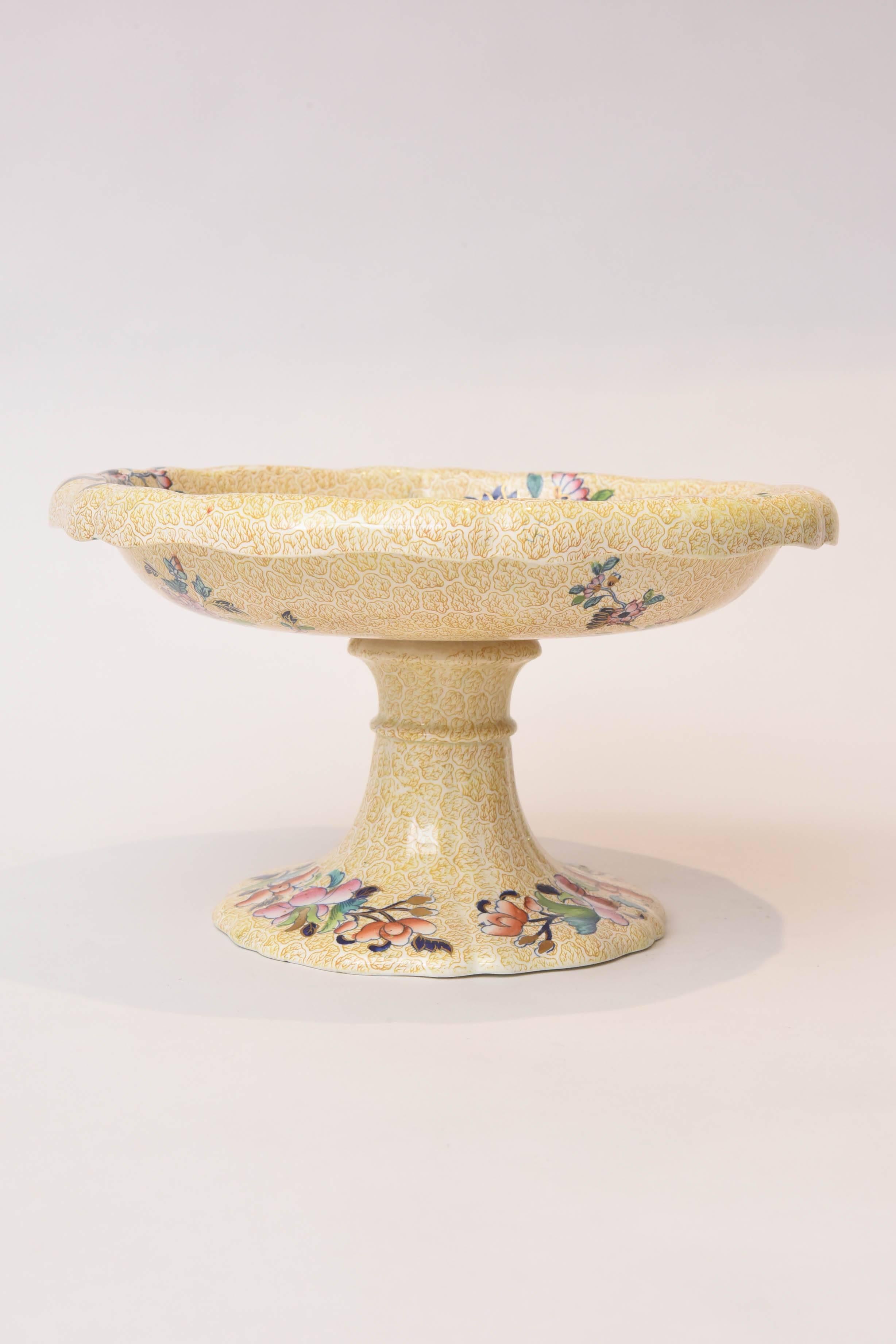 A Copeland Spode centerpiece compote in a charming version of their peacock and parsley design, circa 1820. Featuring an all-over scroll on a buttercream yellow ground and vibrant pattern through the center, base and even underneath the bowl. In