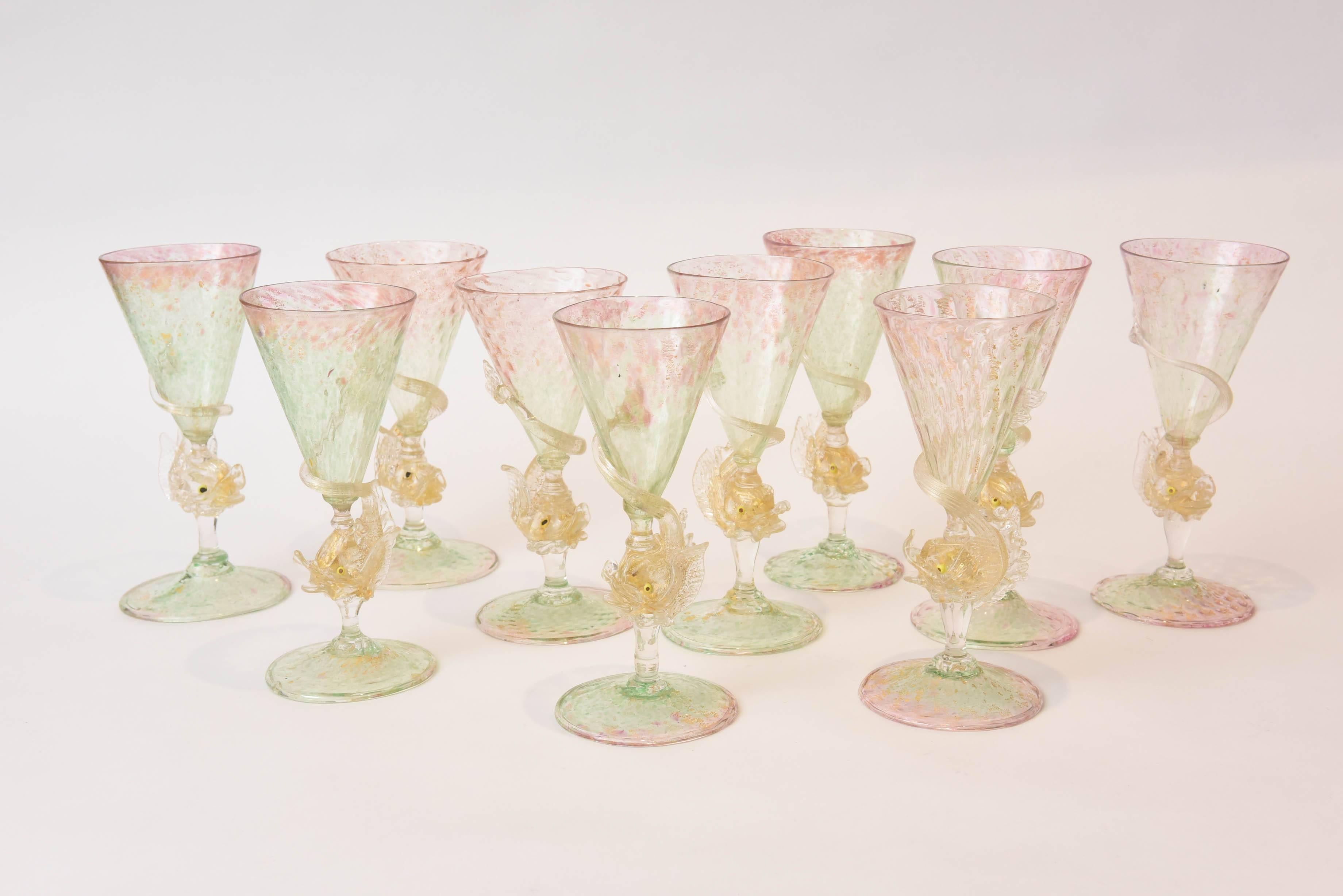 Antique goblets all individually mouth blown featuring a double color of pale and pretty pink and green. The dolphin base with its tail fully circling playfully around each stem and highlighted with all-over 24-karat blown gold inclusion. From one